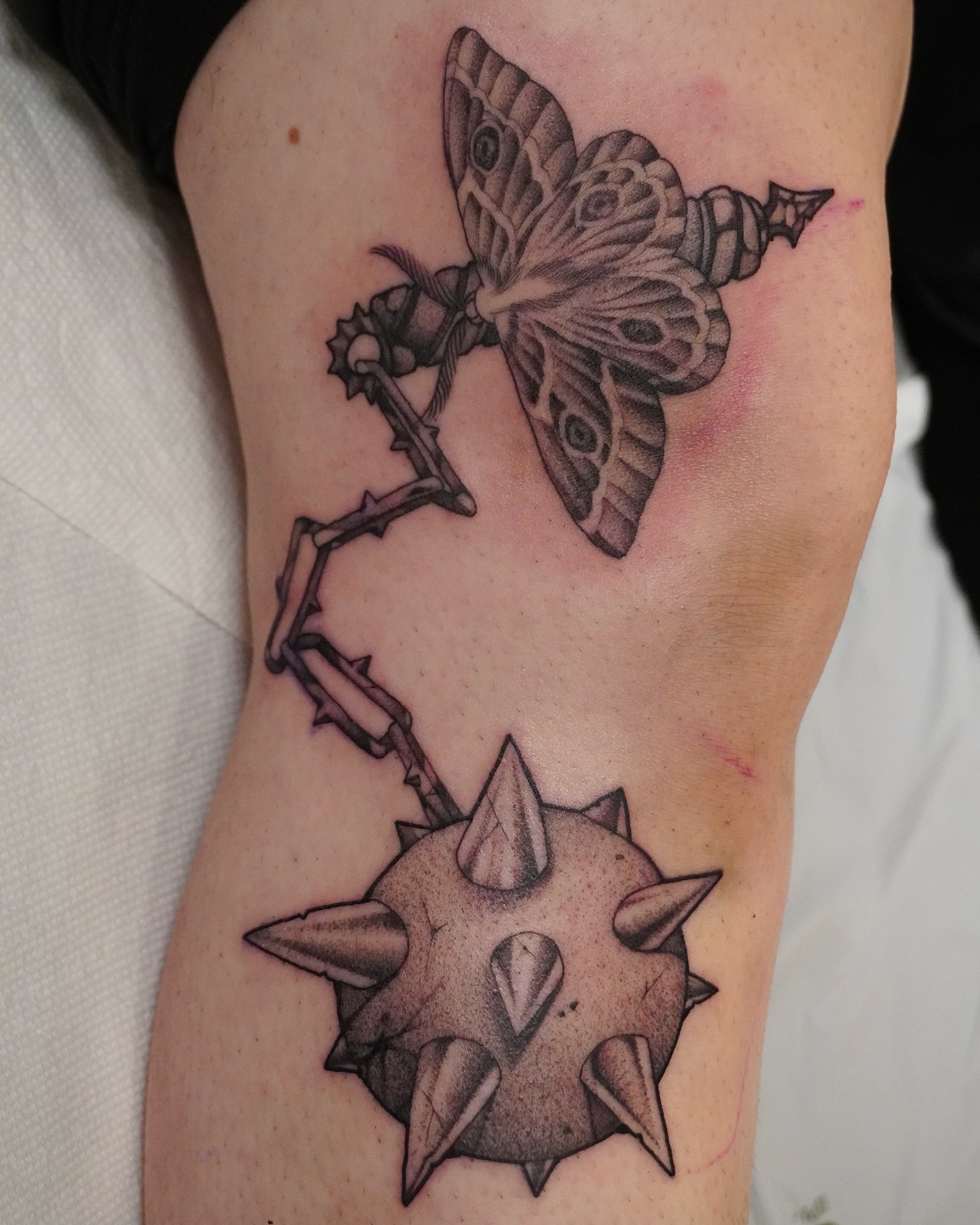 Butterfly and spiked orb geometric tattoo on the forearm by abigail 🌸