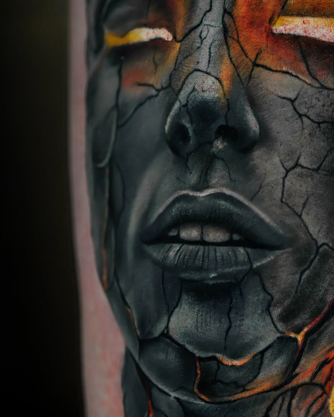 Cracked face with glowing eyes surrealism tattoo on the forearm by Felipe Andrade