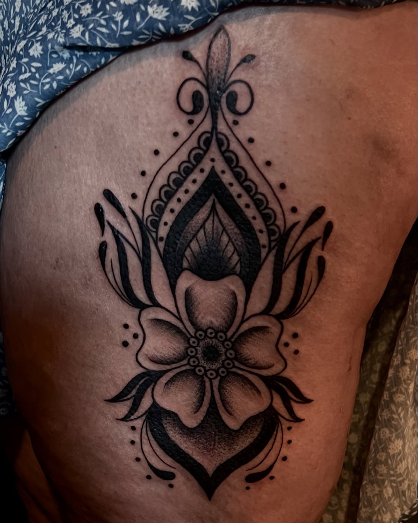 Lotus flower geometric tattoo on the thigh by Stevie Reign