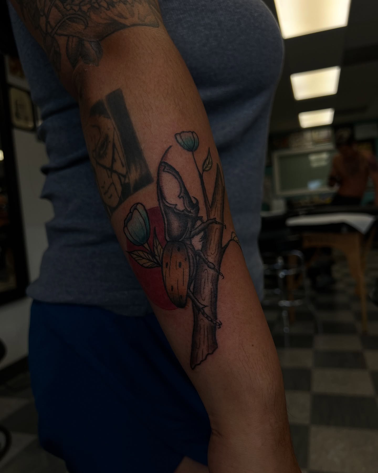 Apple and tulips realism tattoo on the forearm by Stevie Reign
