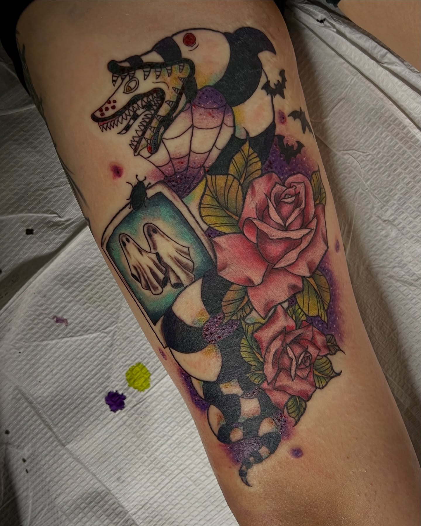 Snake and roses American traditional tattoo on the thigh by Stevie Reign