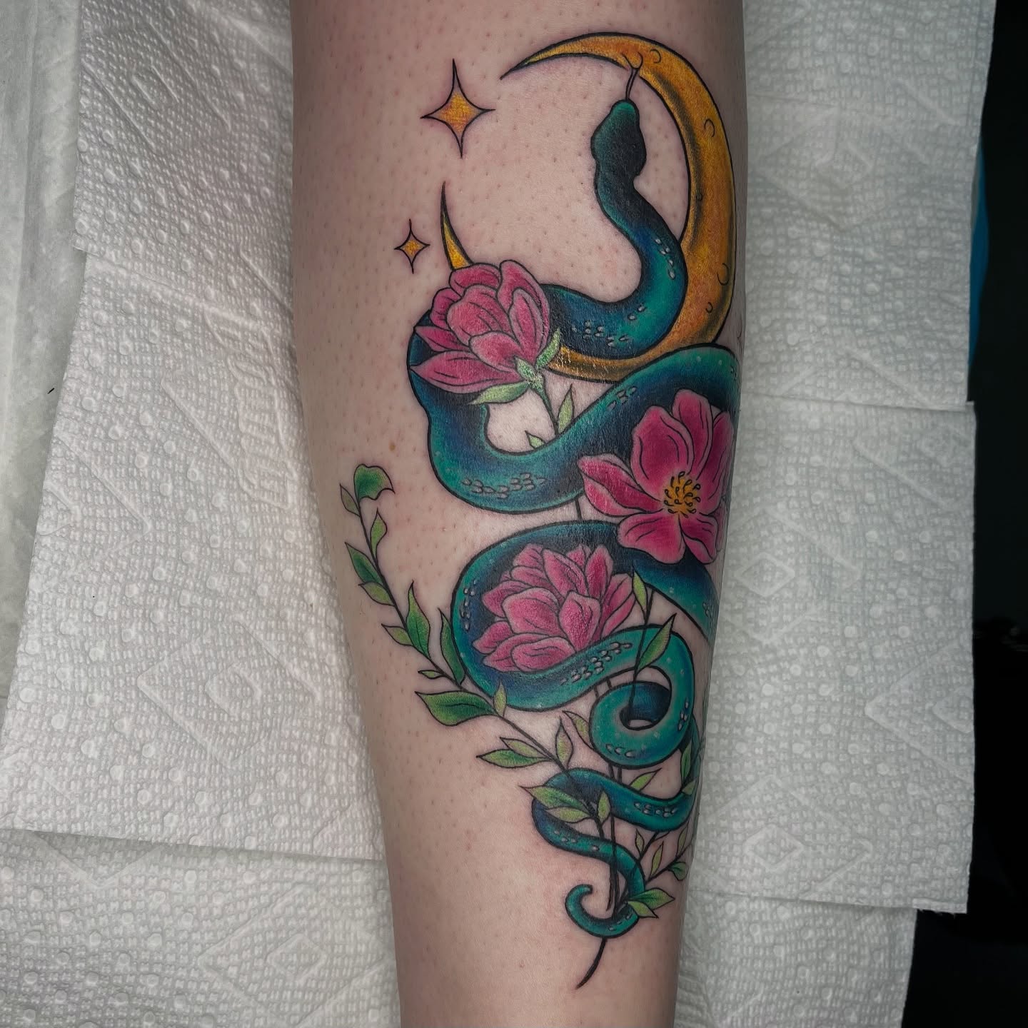 Snake and flowers new school tattoo on the forearm by Krystal ✨