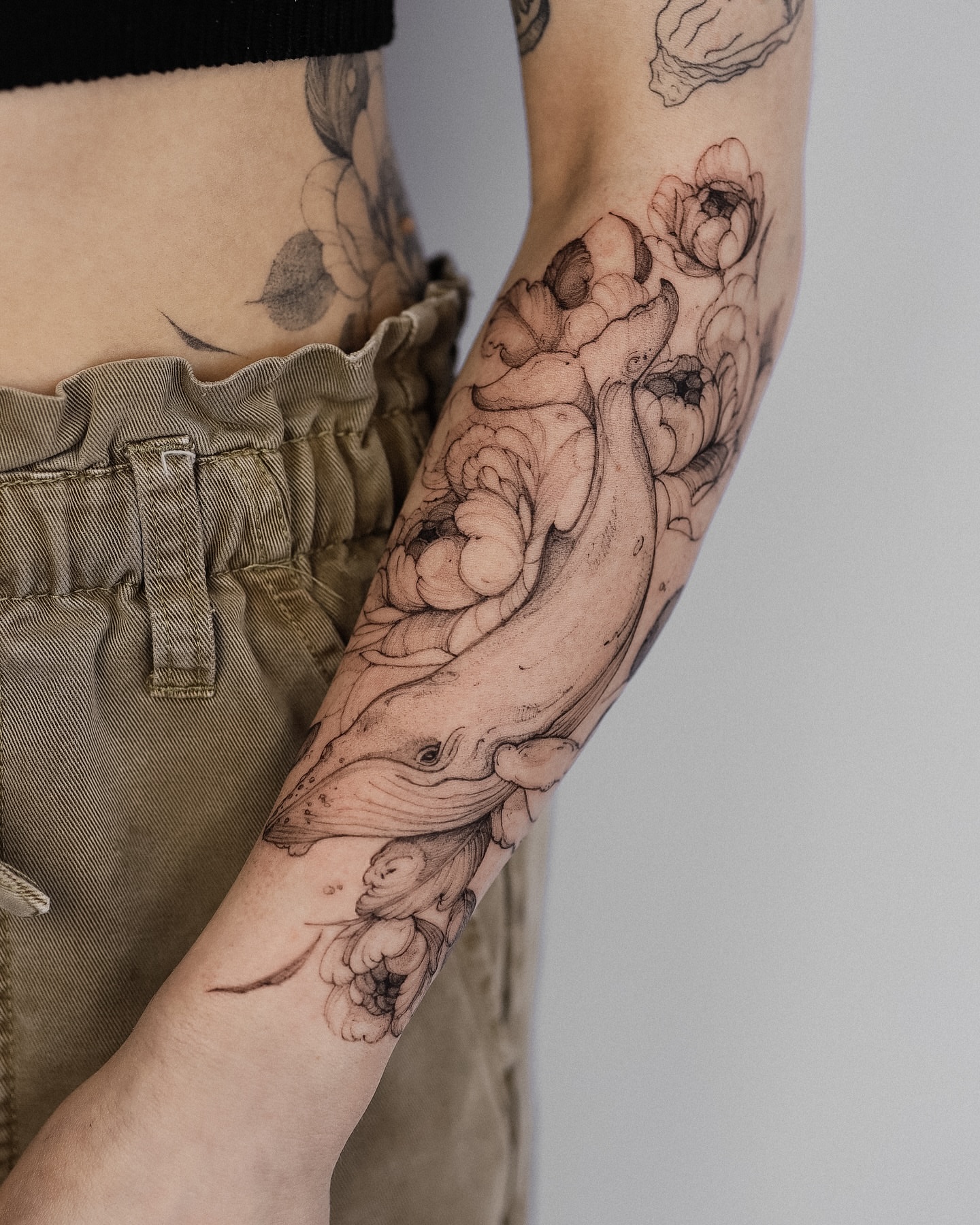 Whale and flowers realism tattoo on the forearm by Maria