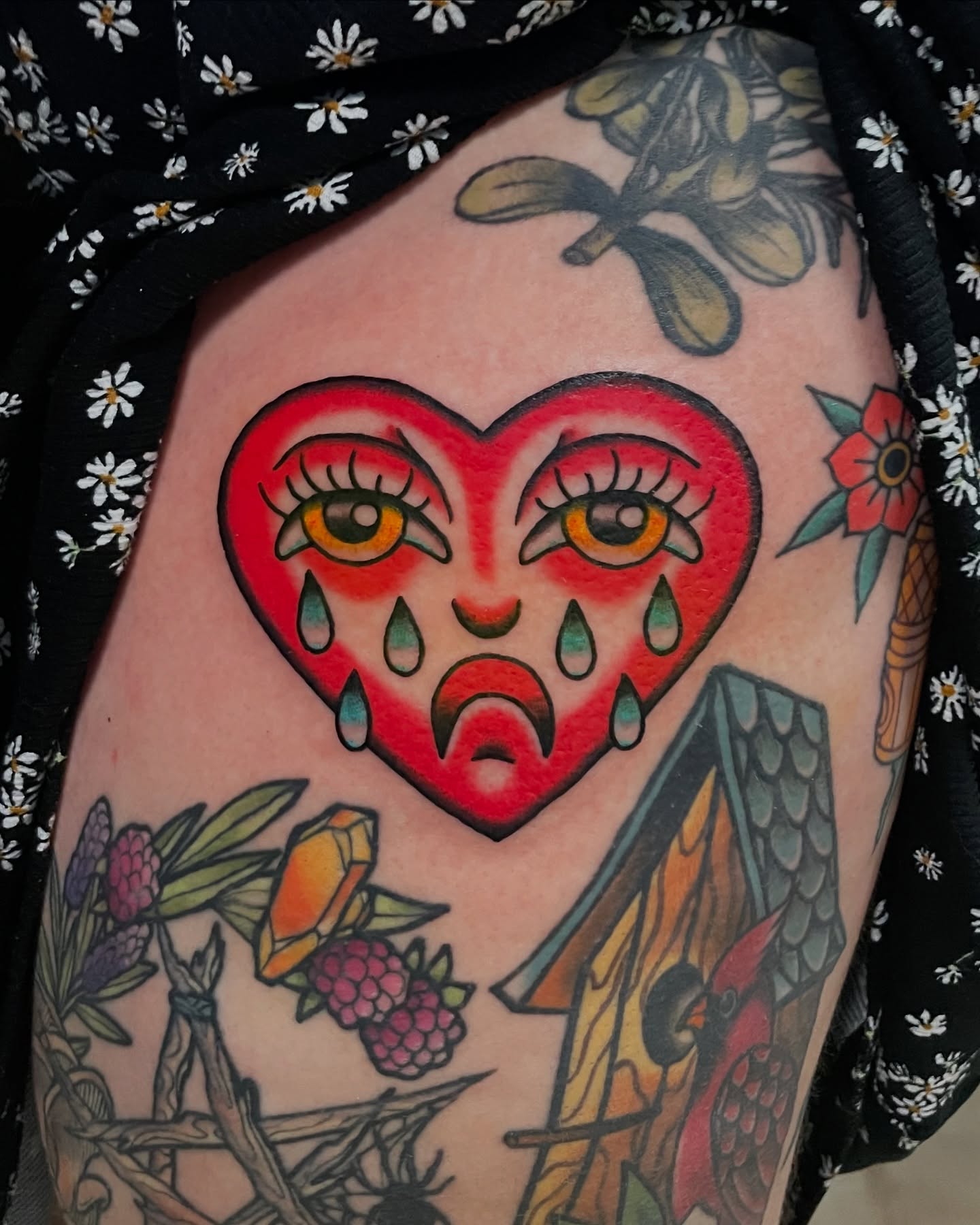 Heart with eyes American traditional tattoo on the thigh by Candence Smith