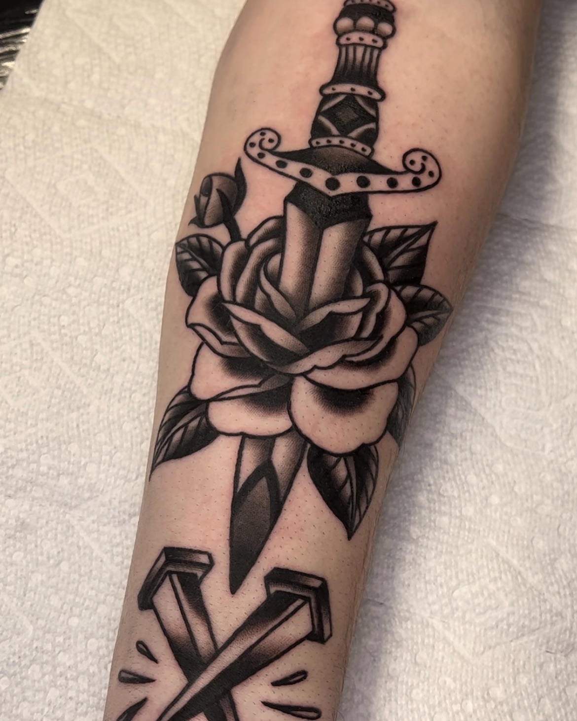Sword and rose American traditional tattoo on the forearm by Cory Allen