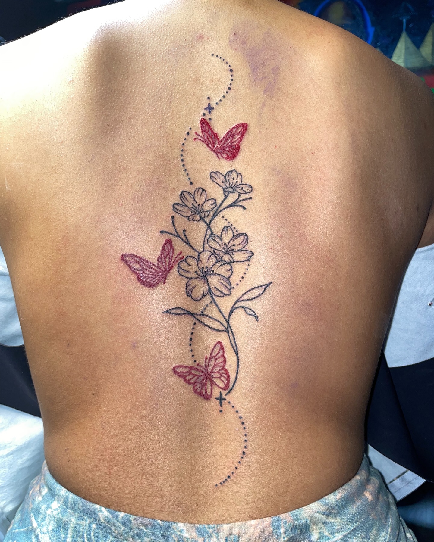 Flowers and butterflies dotwork tattoo on the back by Vanessa - Dallas Artist