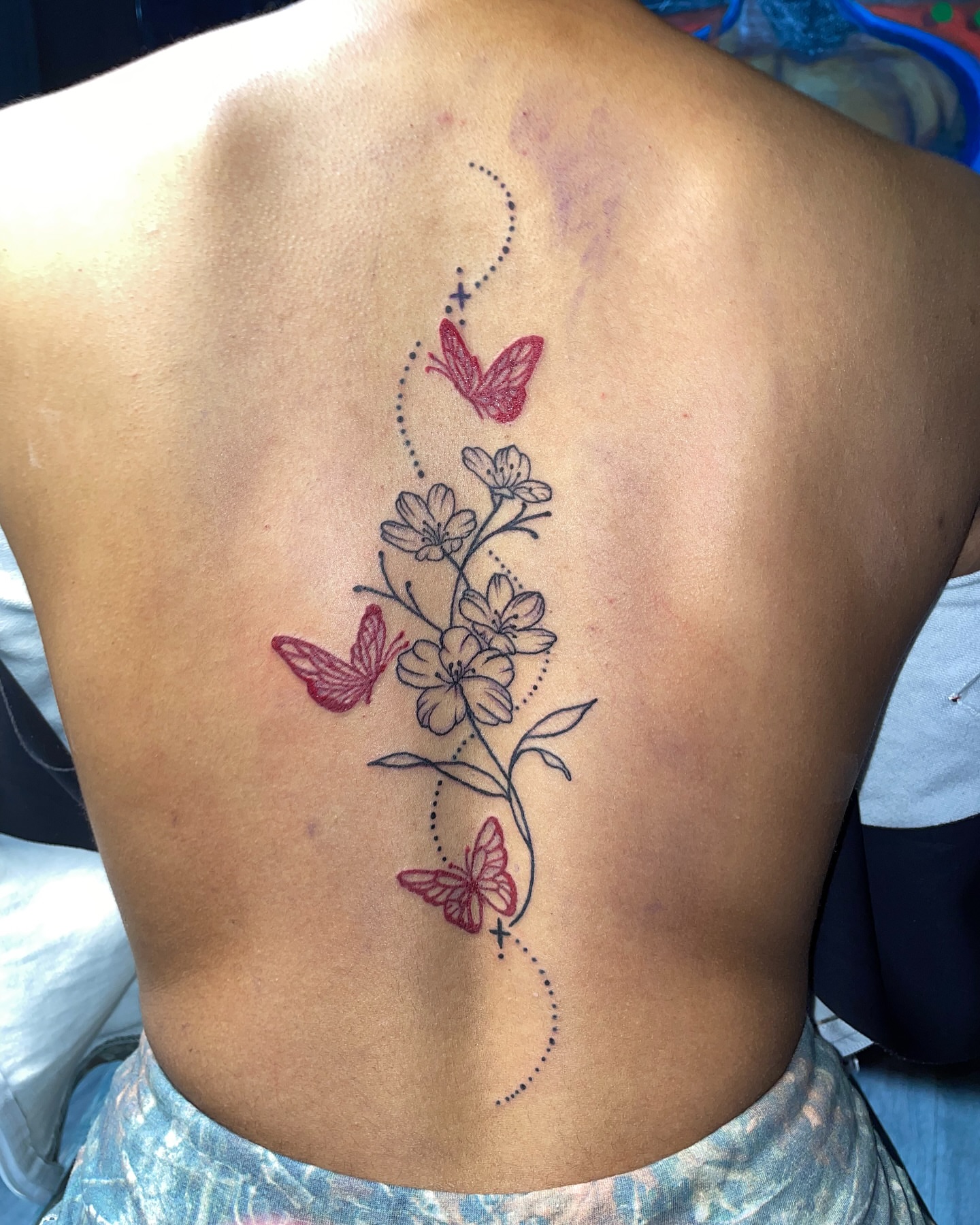 Flowers and butterflies dotwork tattoo on the back by Vanessa - Dallas Artist