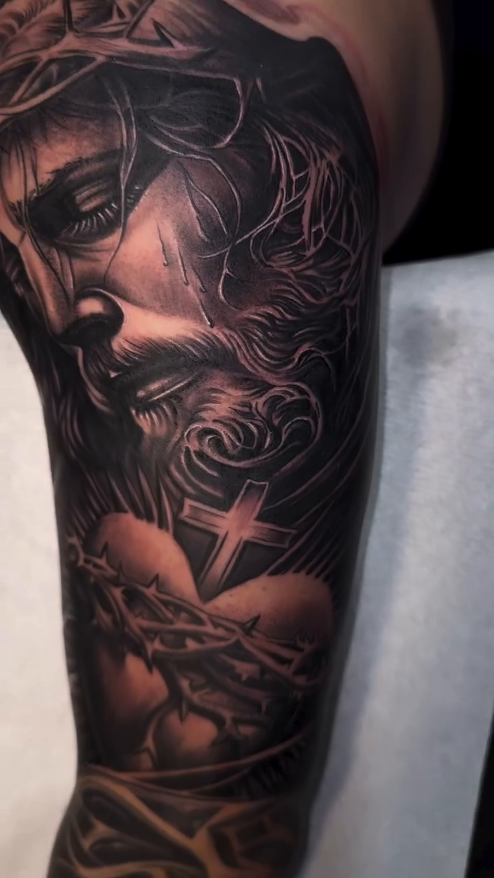 Jesus Christ and religious imagery realism tattoo by Tattoo