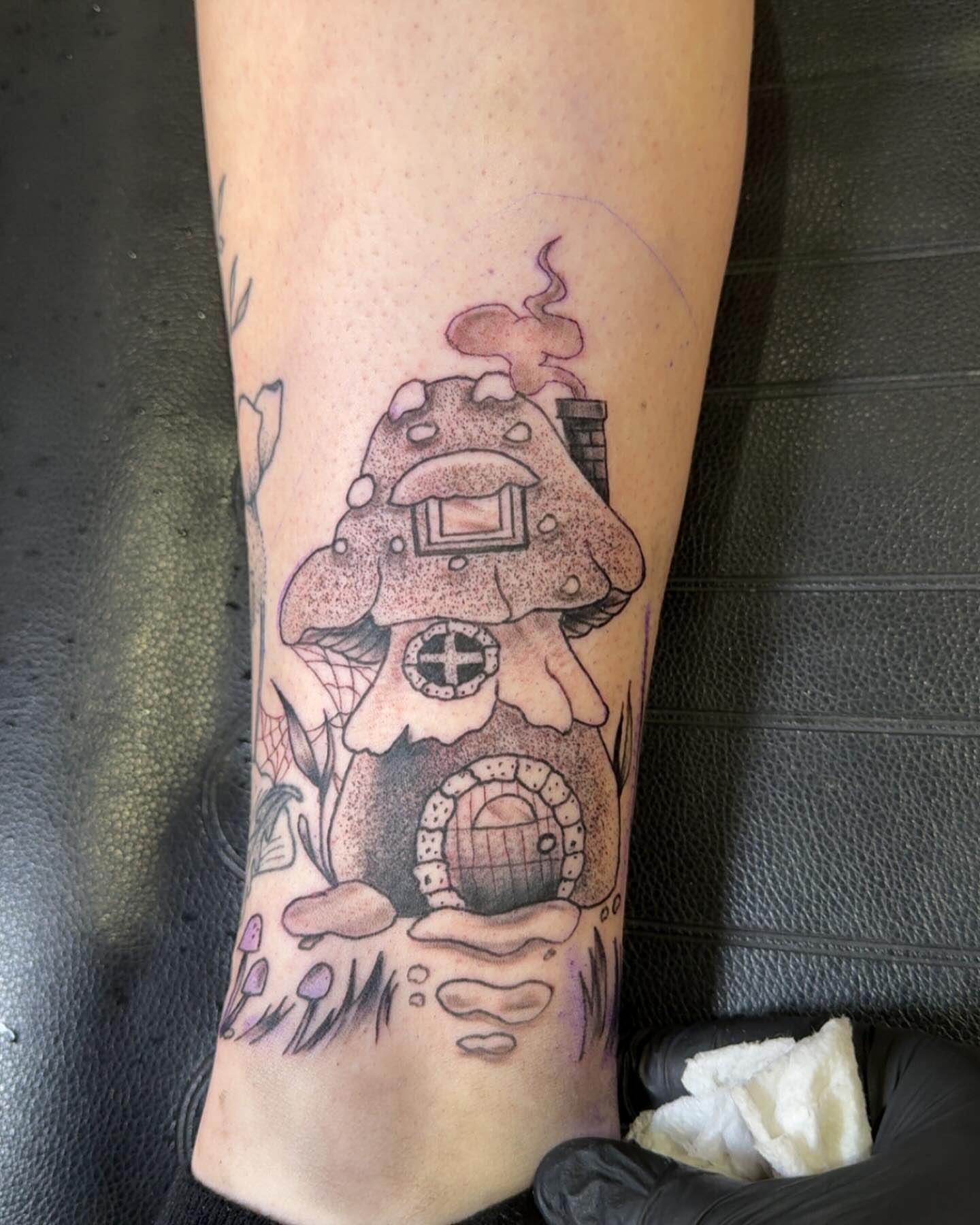 Mushroom house dotwork tattoo on the forearm by Robbie Roberson