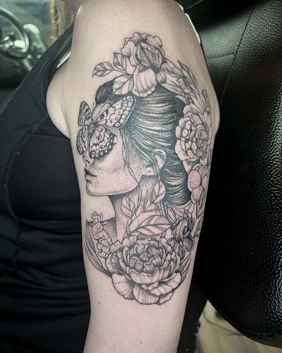 Woman with butterflies and flowers dotwork tattoo on the forearm by amanda malia wega