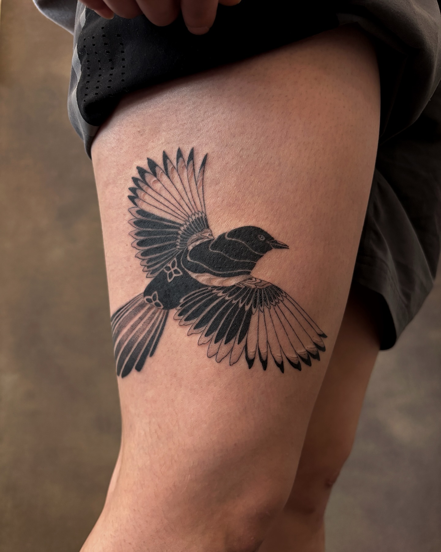 Bird black and grey tattoo on the thigh by sago, Berkeley, California