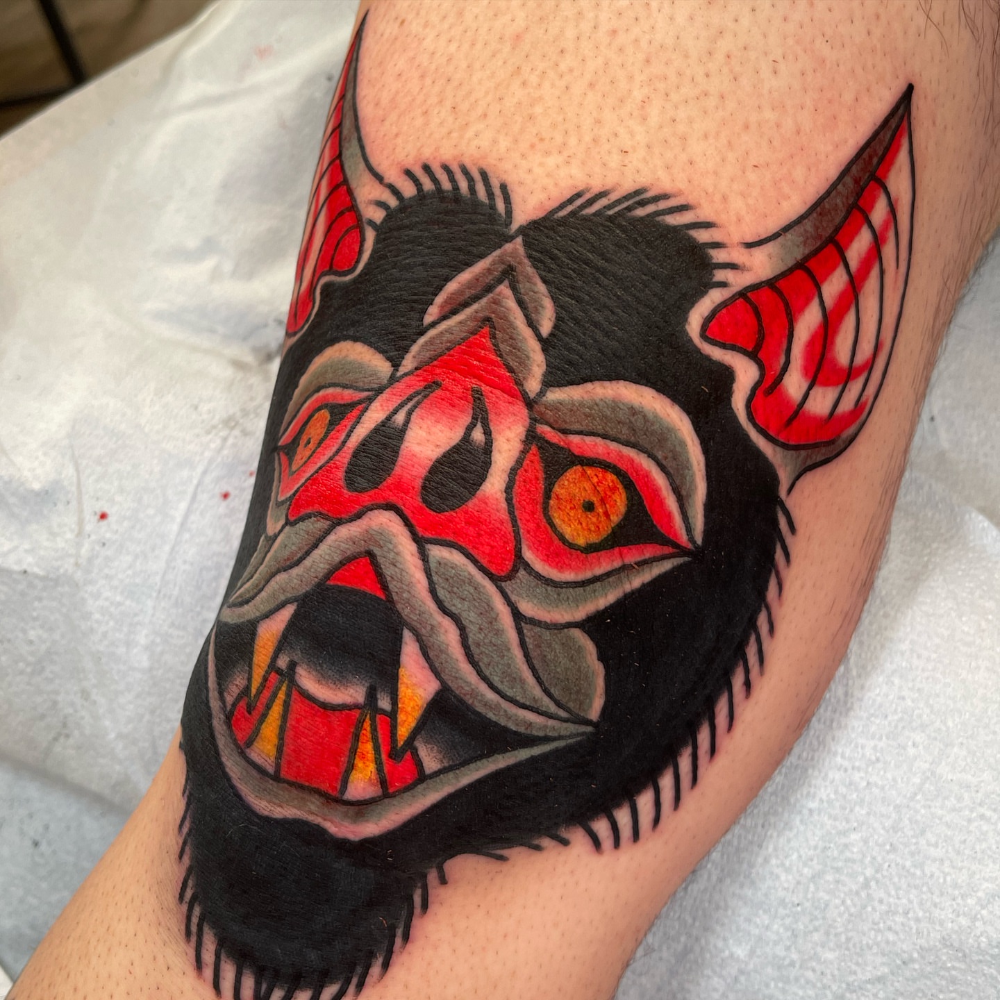 Demon mask American traditional tattoo on the forearm by Jeff Miller philly traditional tattoo
