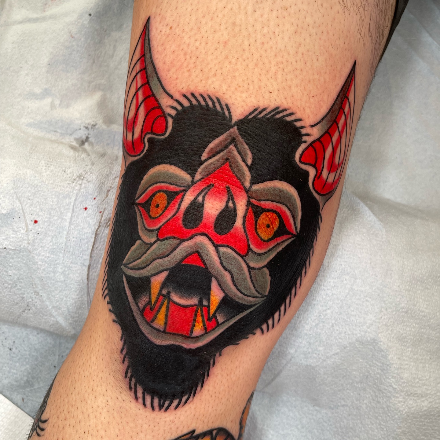 Demon mask American traditional tattoo on the forearm by Jeff Miller philly traditional tattoo