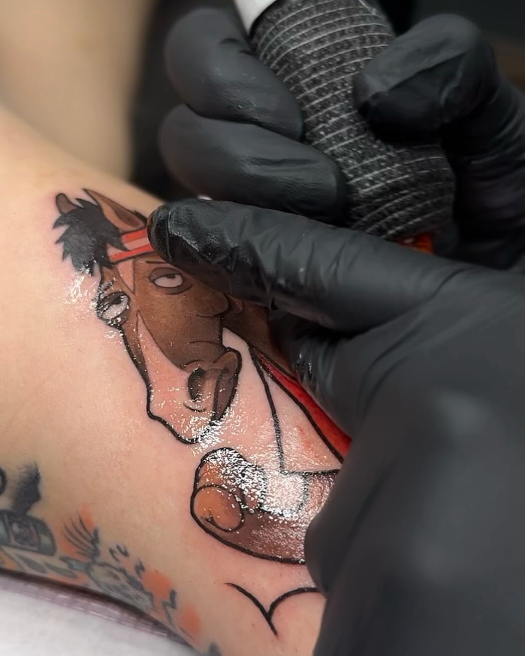 Horse and rider realism tattoo on the upper arm by Lena Aleksandrova
