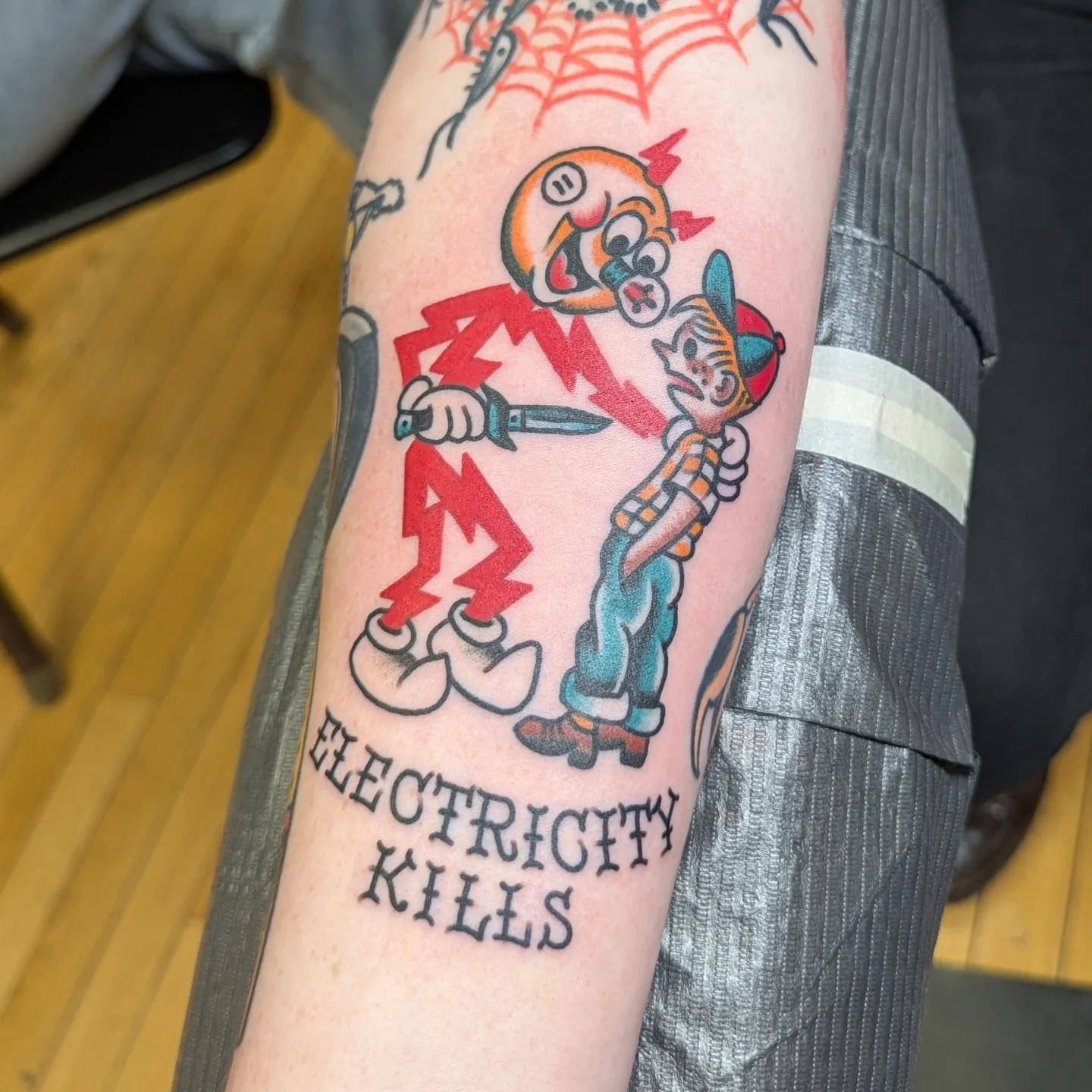 Electricity kills American traditional tattoo on the forearm by Zack Mueller