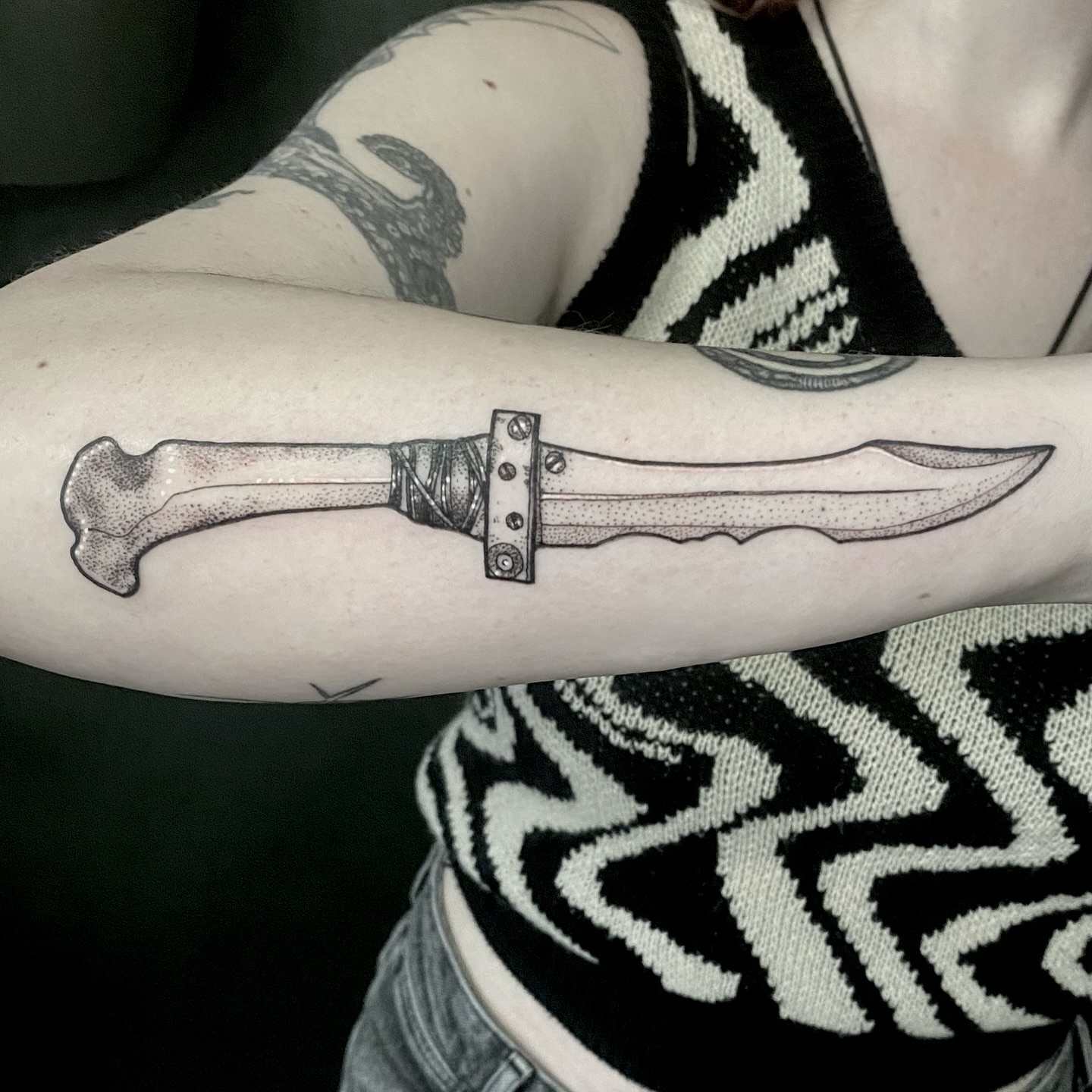 Knife dotwork tattoo on the forearm by Rowan Starr