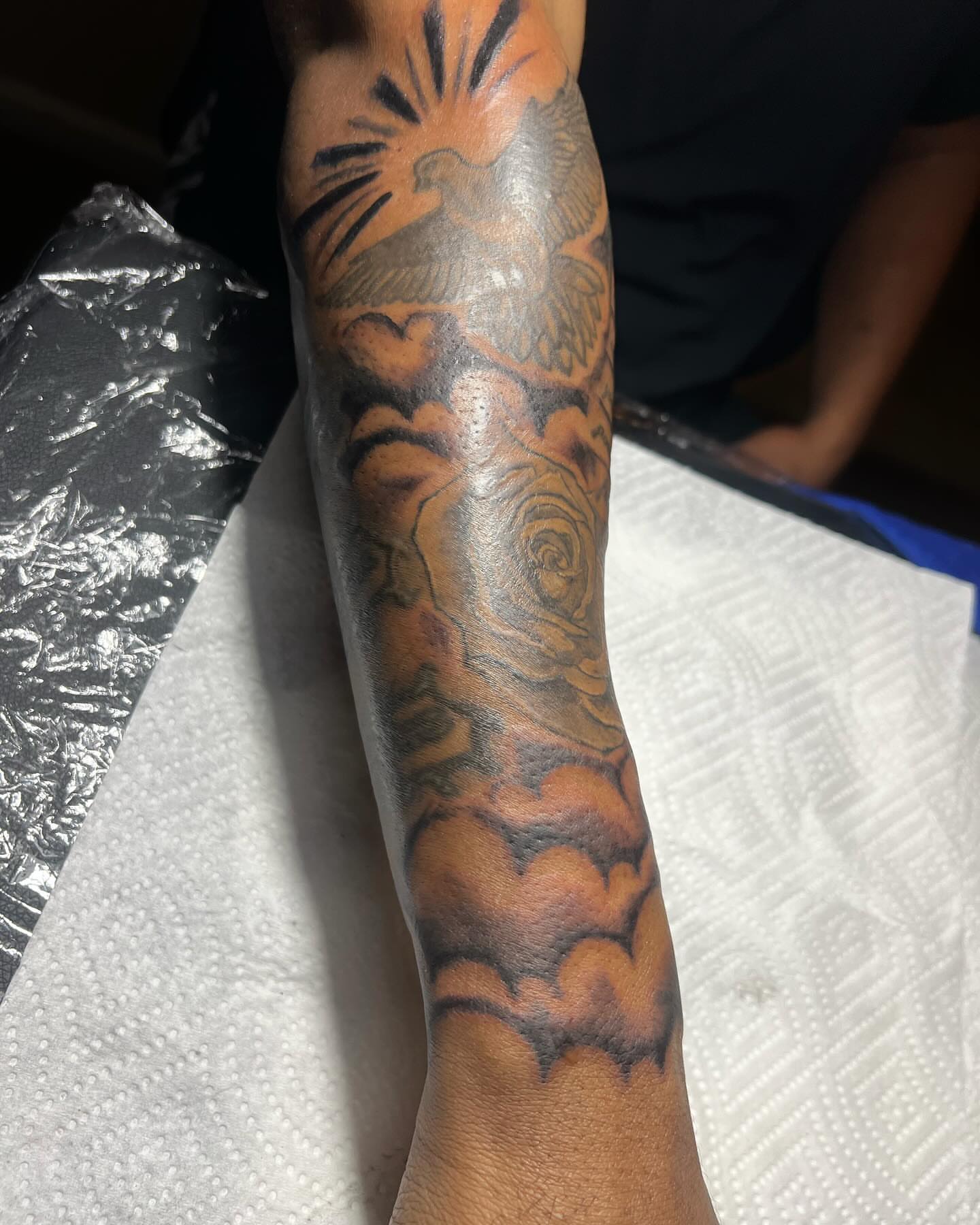 Bird and cloud American traditional tattoo on the forearm by Illuminink.gallery
