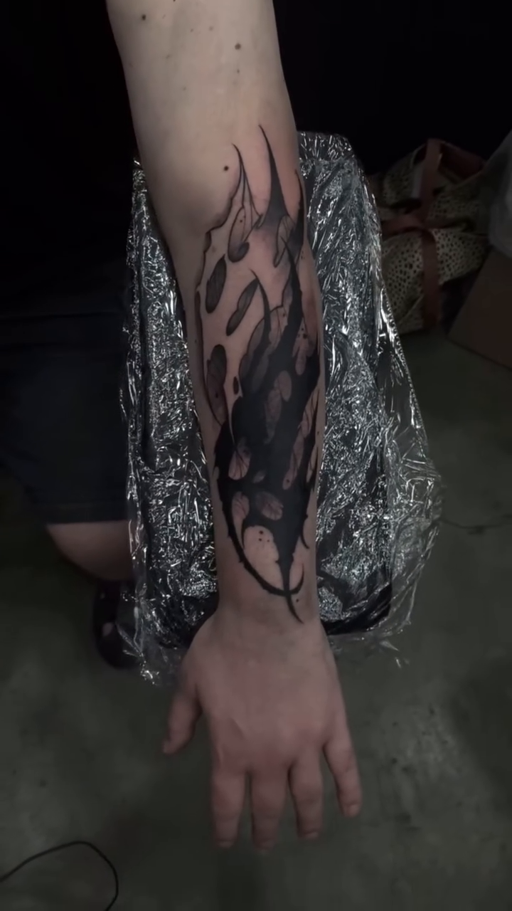 Abstract flame-like shapes blackwork tattoo by Turk