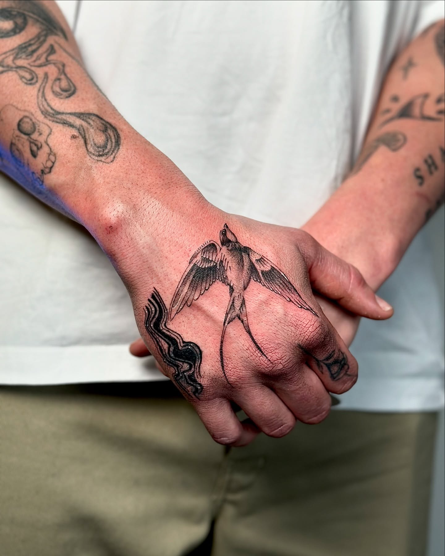Swallow black and grey tattoo on the hand by Fine line tattoo San Diego, San Diego, California