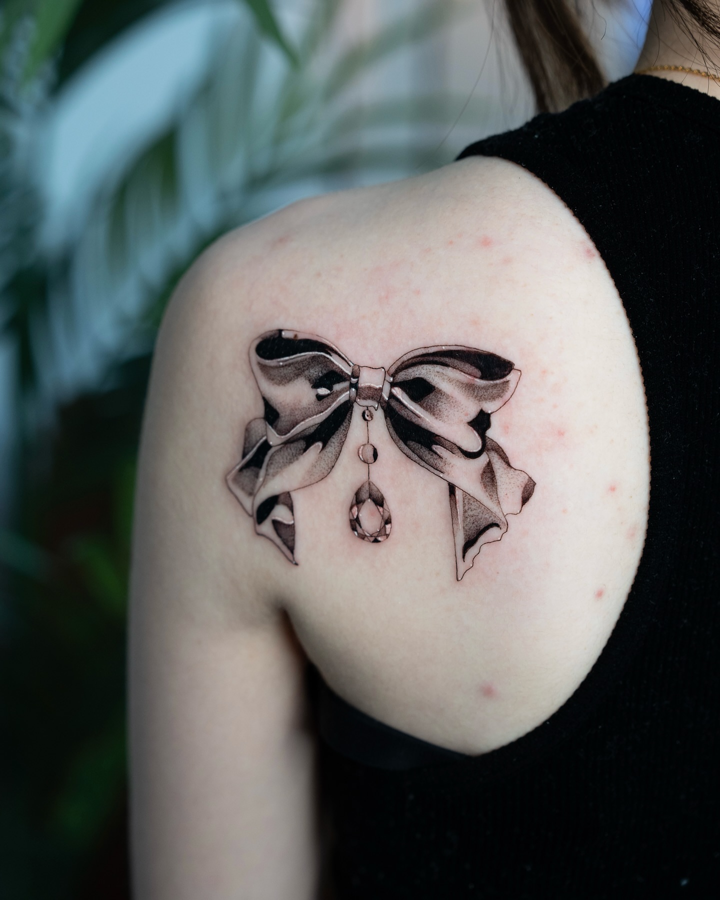Bow black and grey tattoo on the shoulder by Fine line tattoo San Diego, San Diego, California