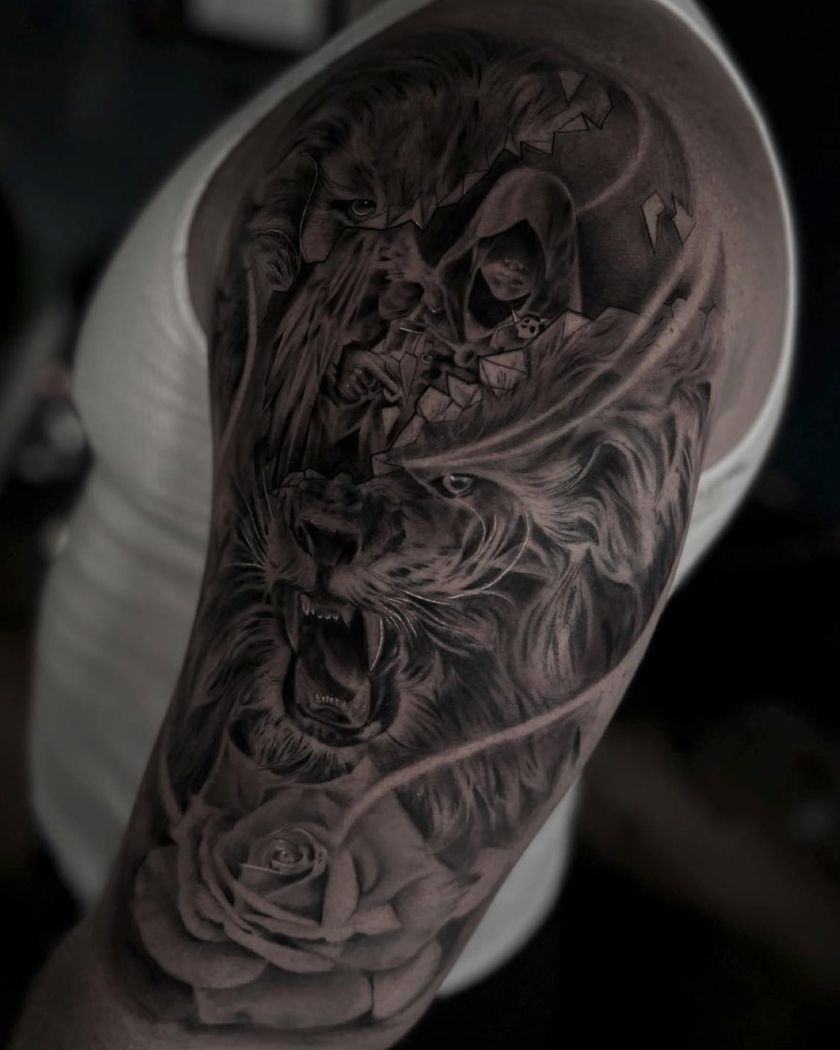 Lion and hooded figure realism tattoo on the forearm by Diego Andrés Cárdenas