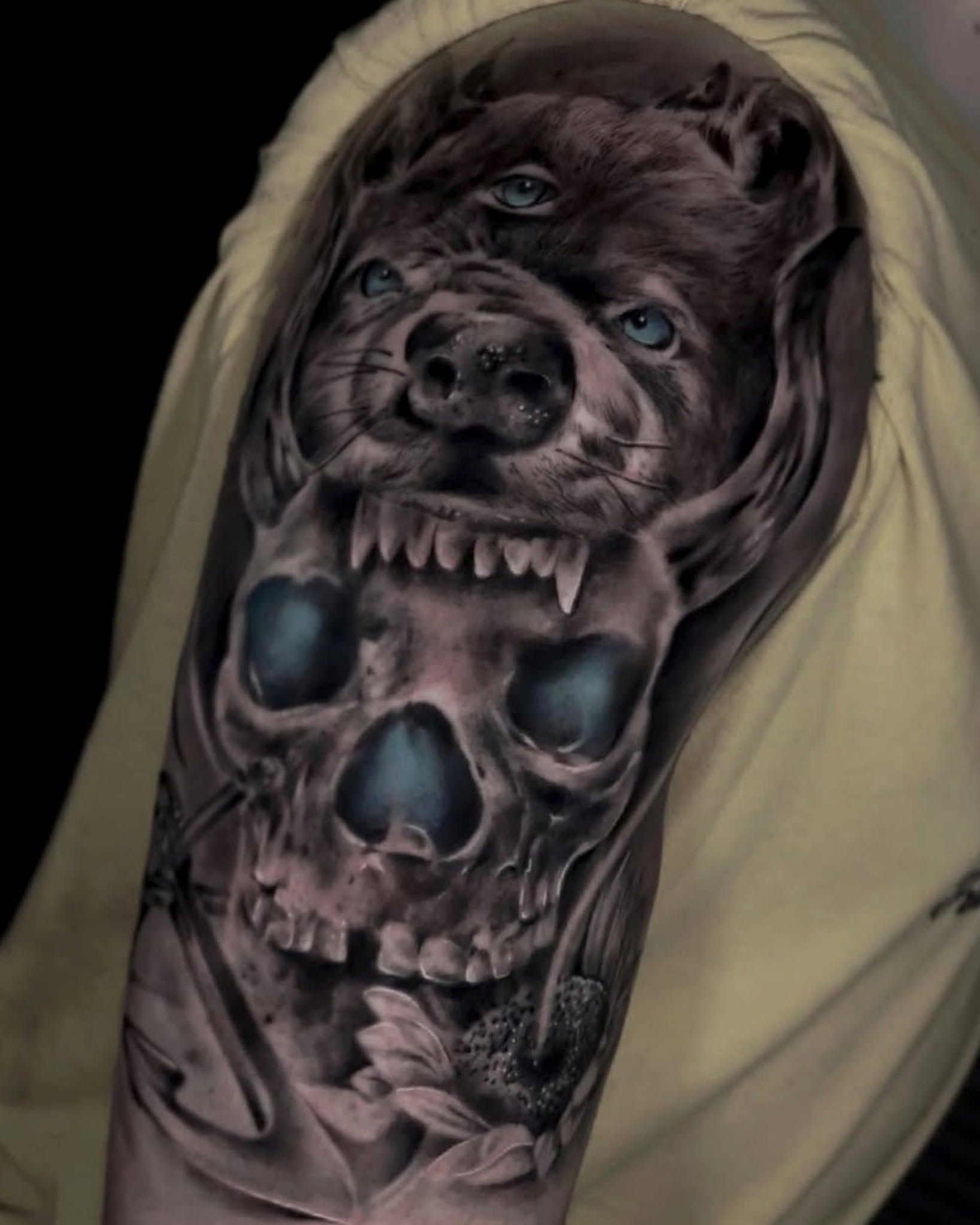 Grinning dog skull realism tattoo on the forearm by Diego Andrés Cárdenas