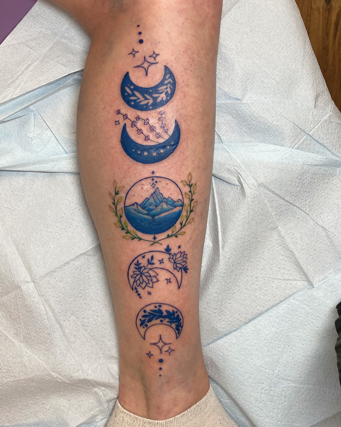 Moon phases dotwork tattoo on the calf by Destinee DeFriece