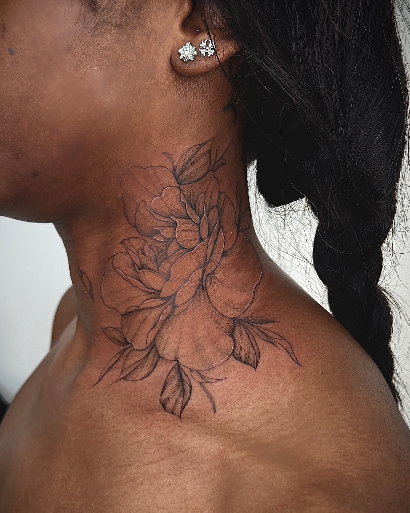 Flowers black and grey tattoo on the neck by Nyc Tattoo Manhattan