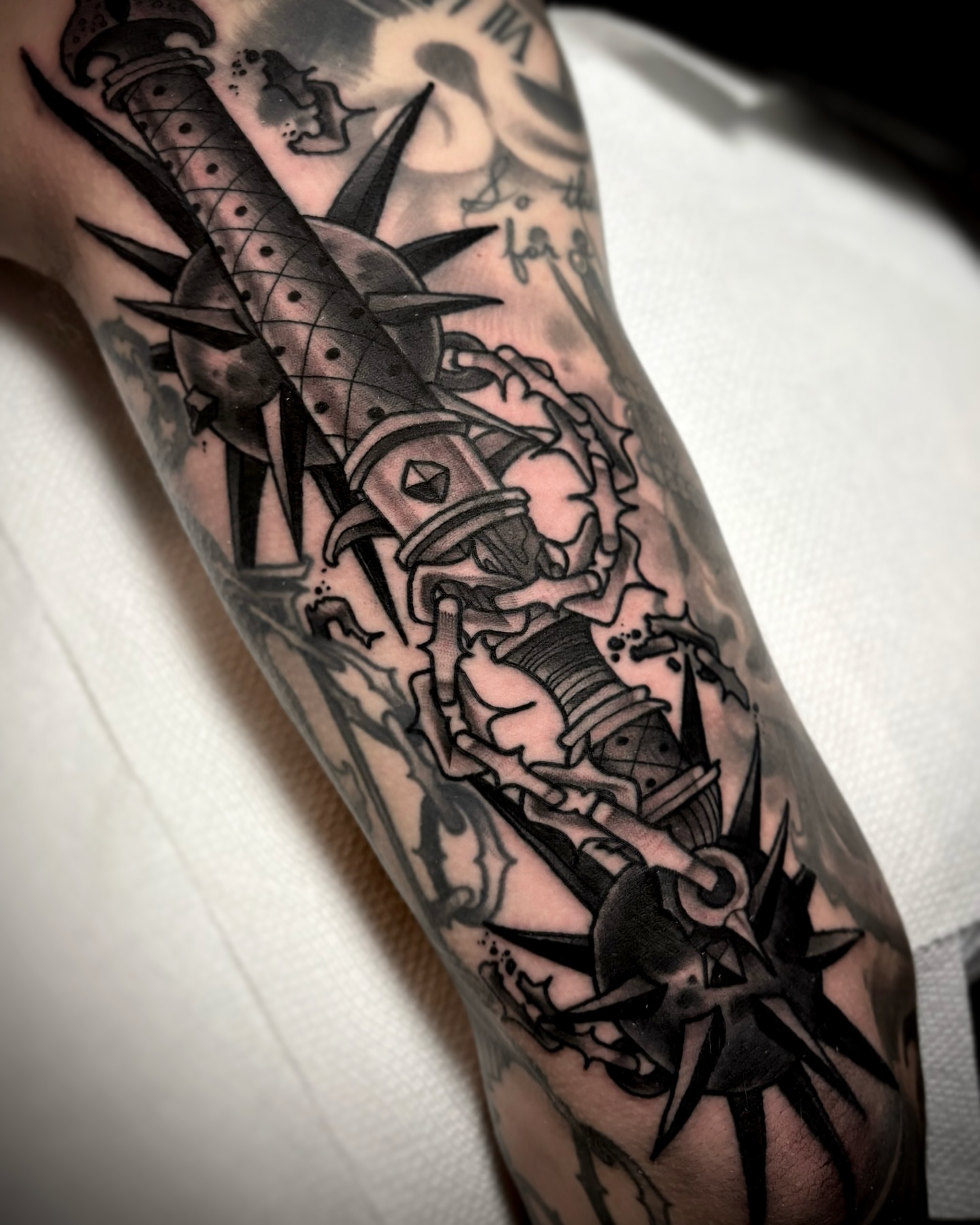 Sword and spikes black and grey tattoo on the forearm by π΅πππ πΎπππππππ, Penndel, Pennsylvania