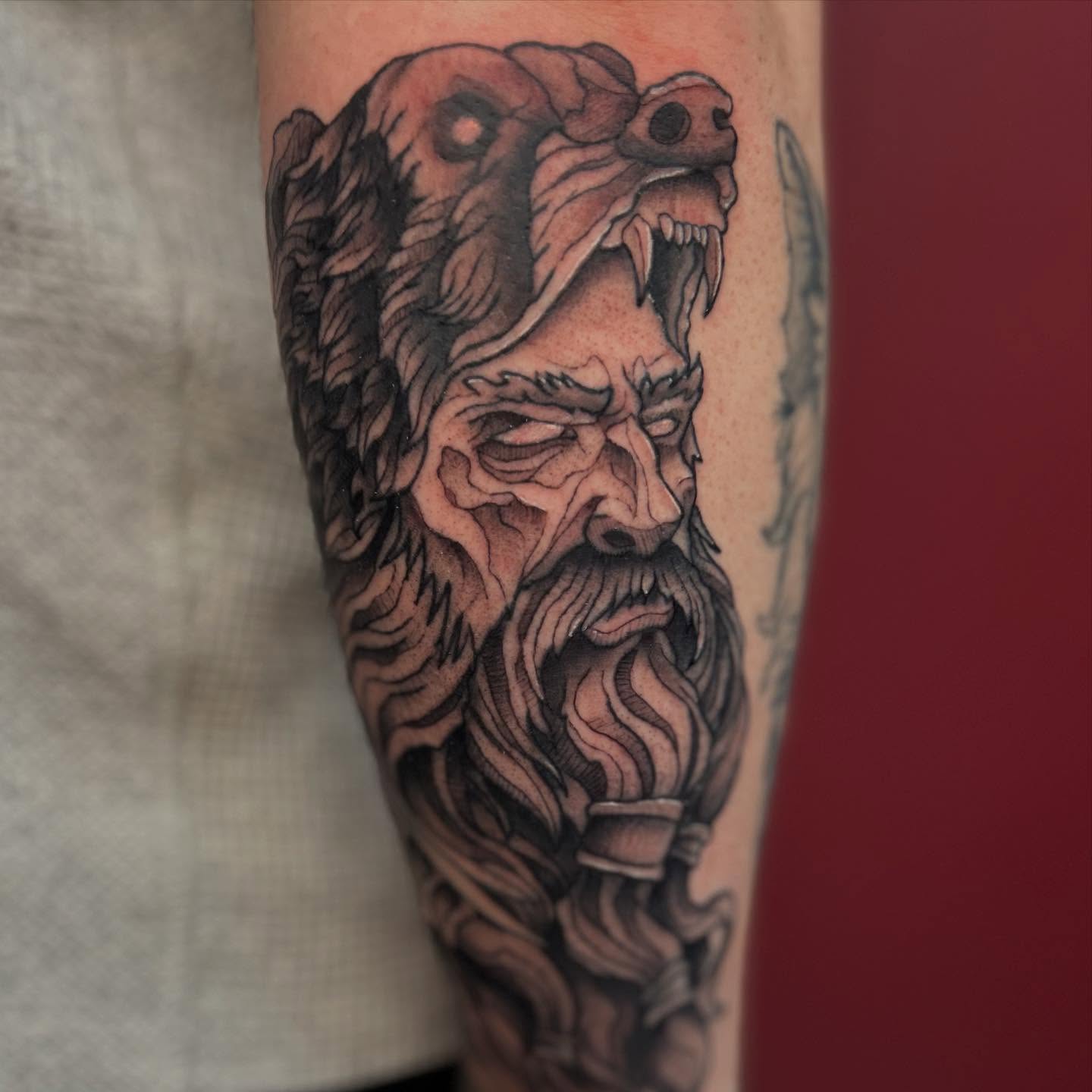Bearded man with snake head realism tattoo on the forearm by Abby Watts, Columbus, Ohio