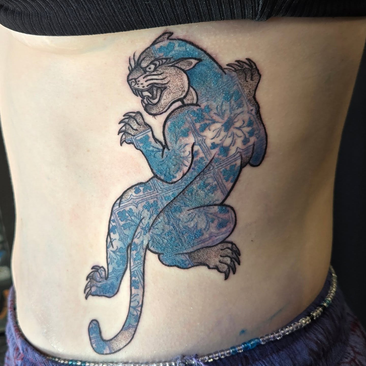 Panther American traditional tattoo on the ribs by Jamie Clinton