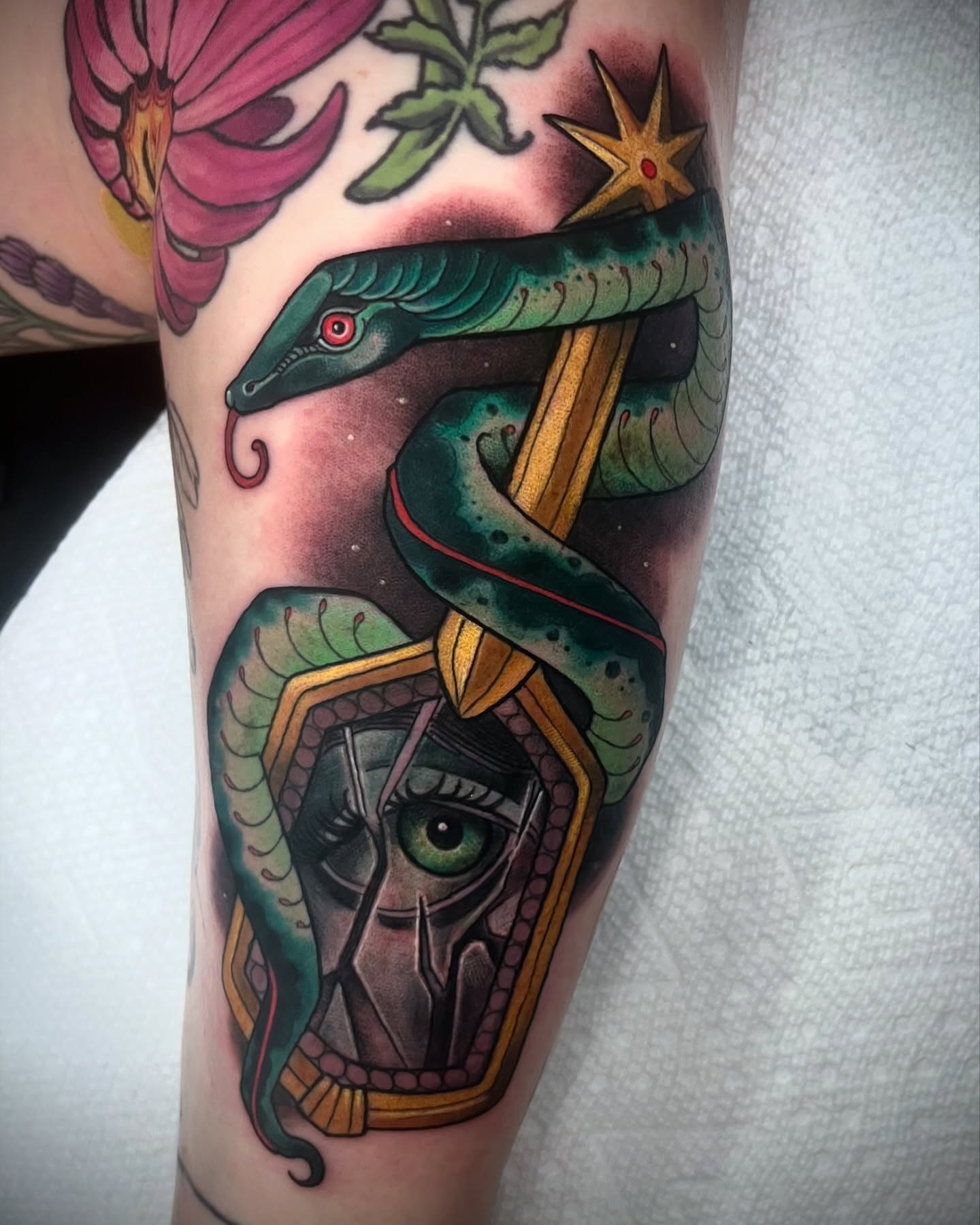 Snake and mask American traditional tattoo on the forearm by Jessica Brown