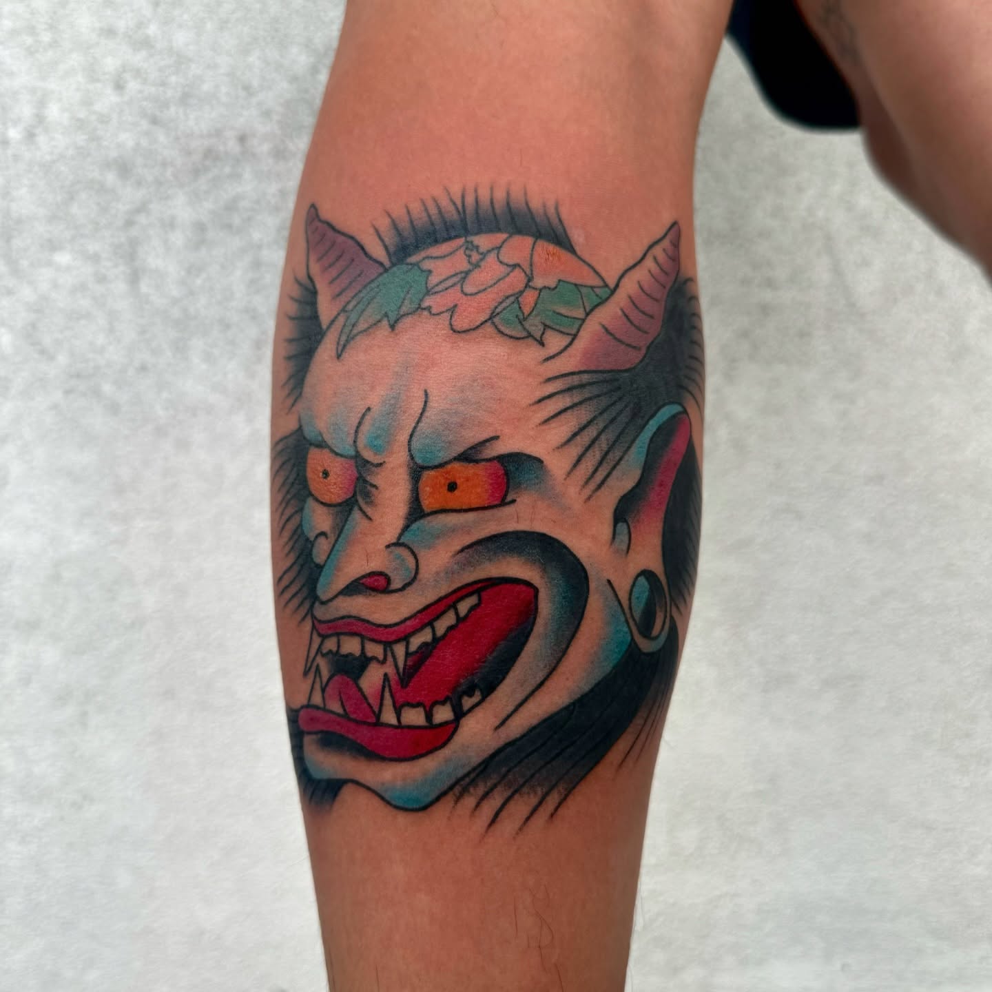 Demon mask American traditional tattoo on the forearm by Drew🕸️, Phoenix, Arizona