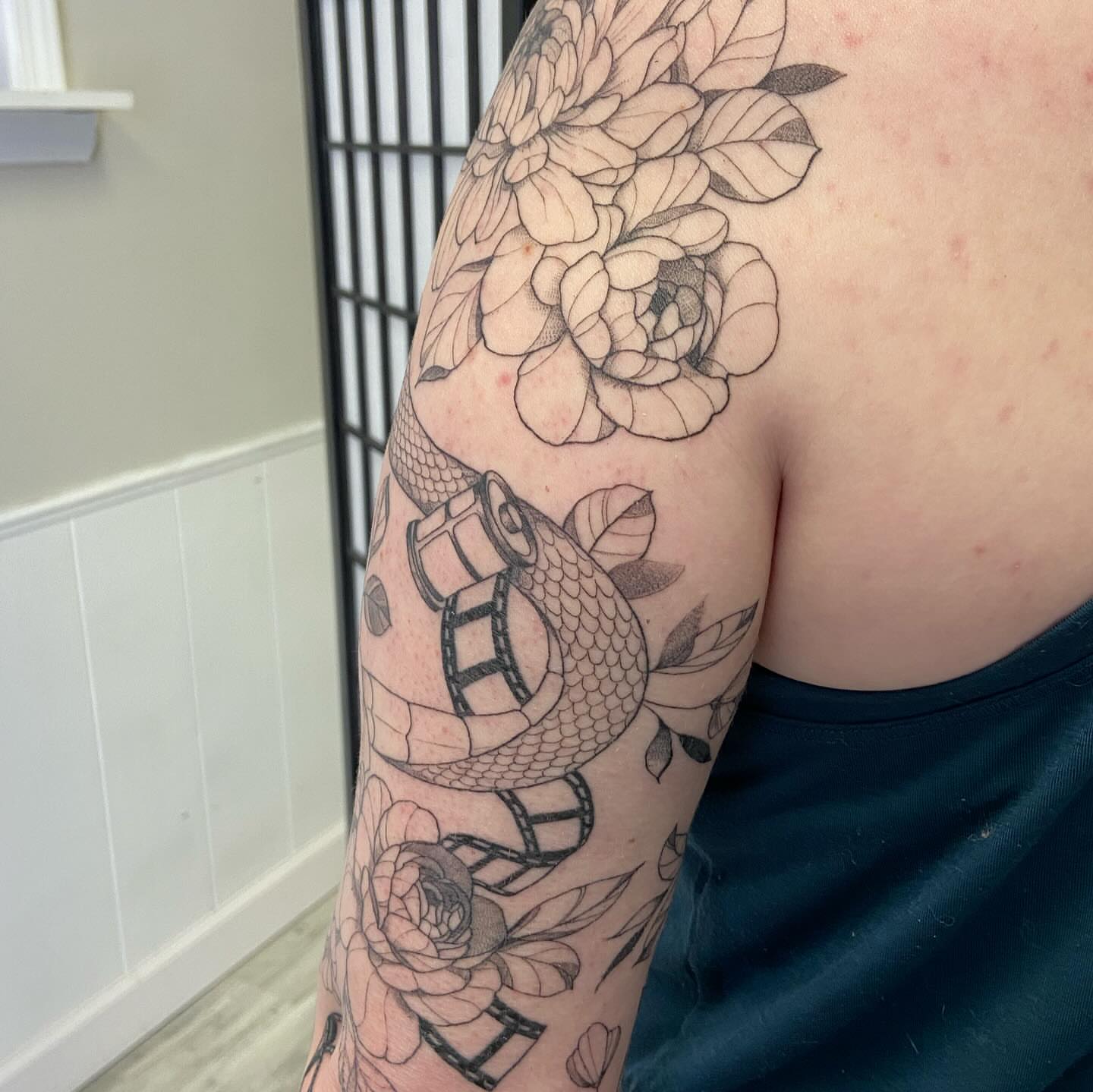 Snake and flowers realism tattoo on the upper arm by Libbey June @ Snailberry Studios- NW OHIO