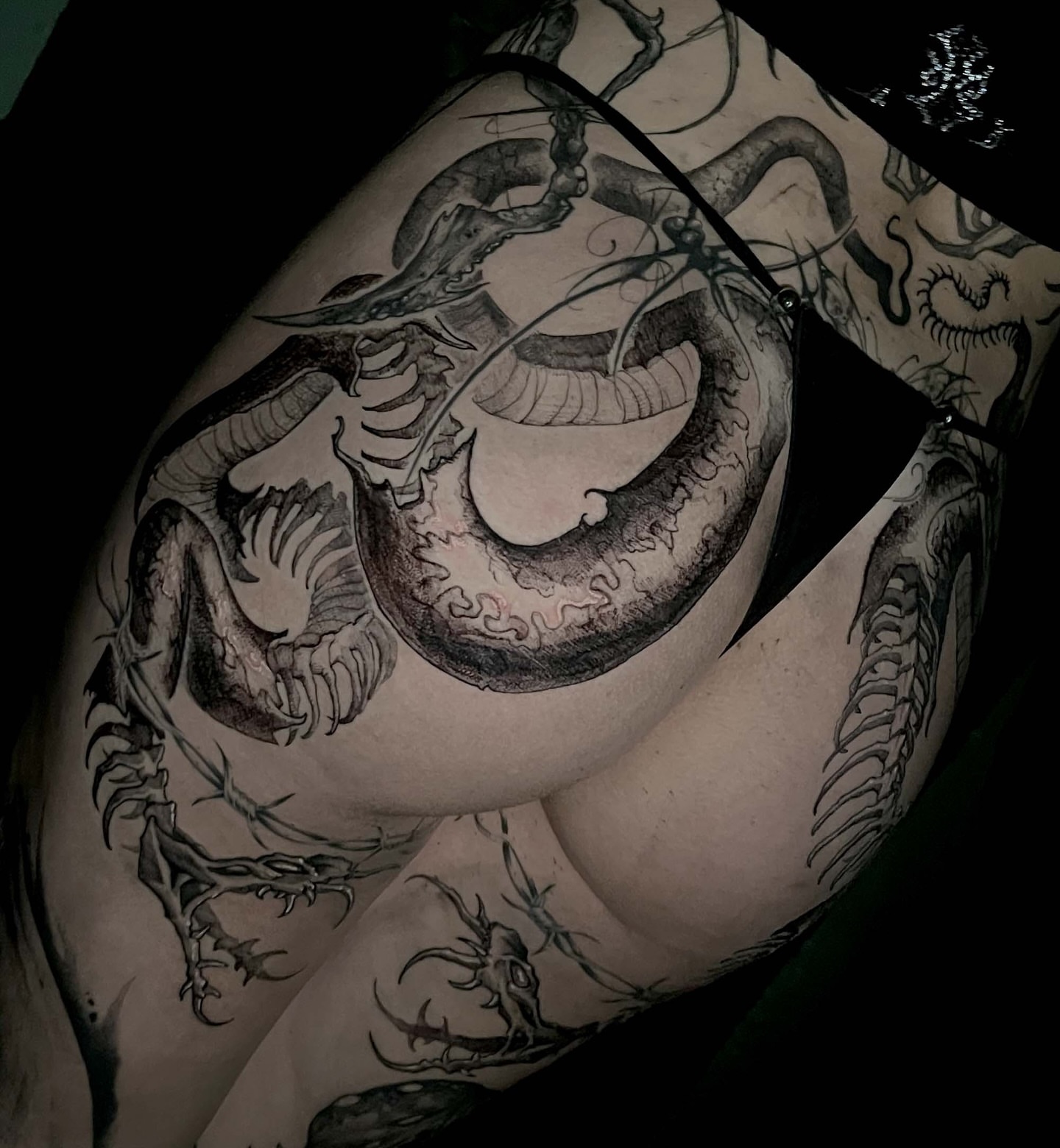 Dragon black and grey tattoo on the thigh by Jamie
