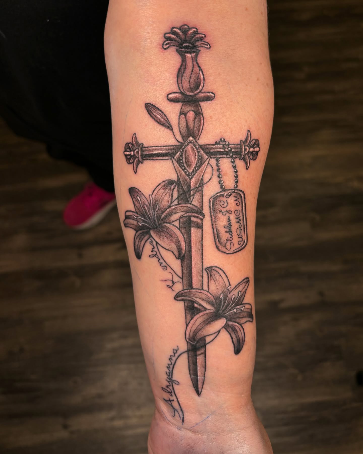 Cross with lilies black and grey tattoo on the forearm by @seibastattoos, Virginia Beach, Virginia