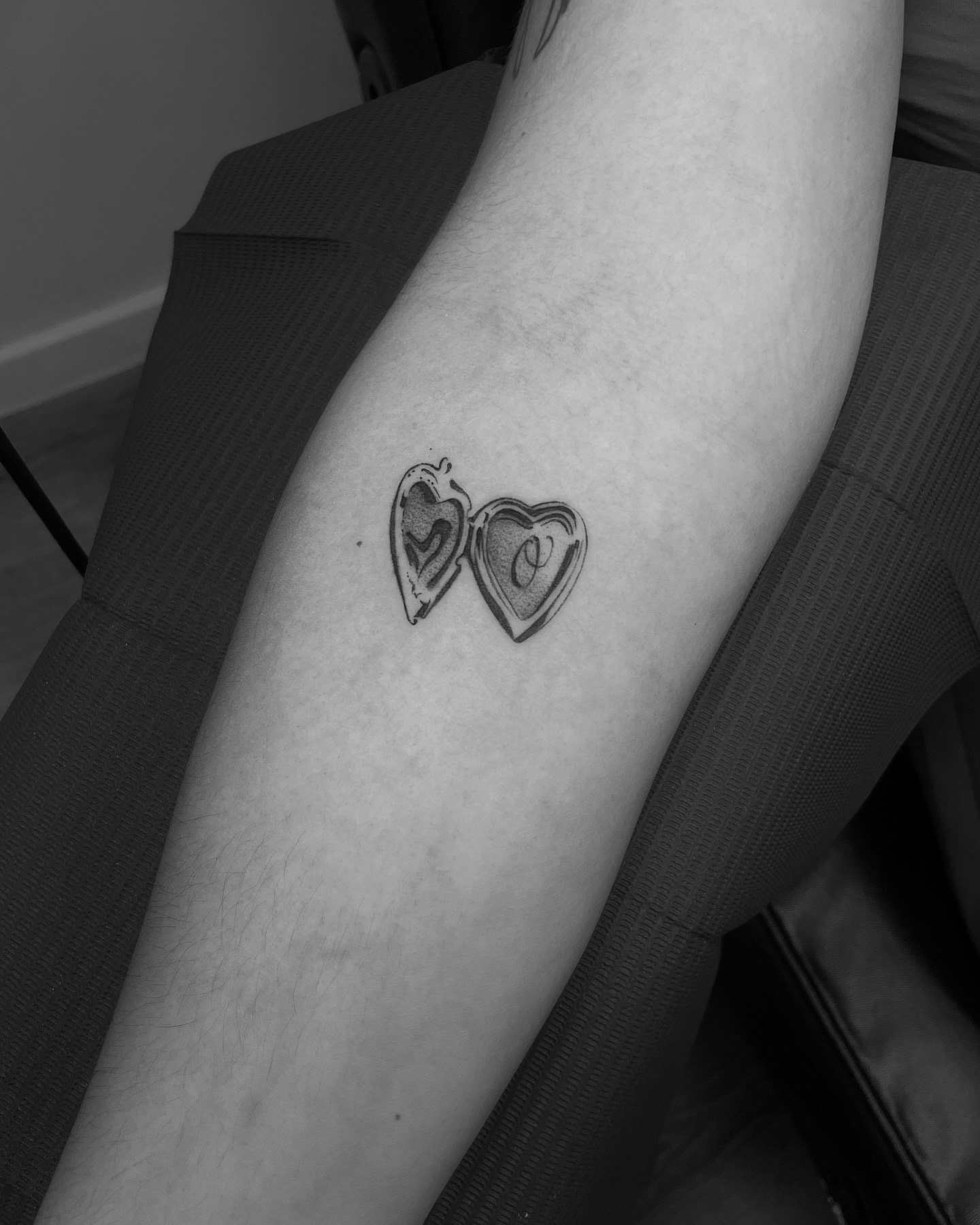 Heart locket black and grey tattoo on the forearm by Vanessa Valdivia