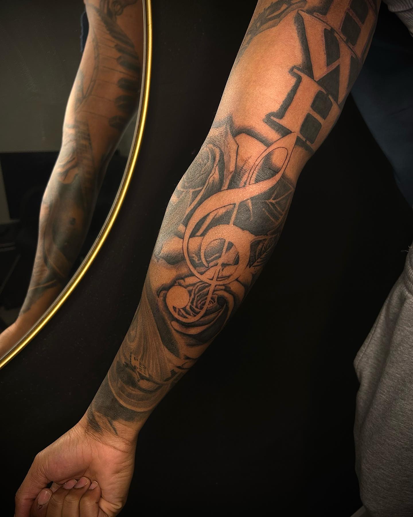 Music notes and roses realism tattoo on the forearm by Cleveland Tattoo Artist, Cleveland, Ohio