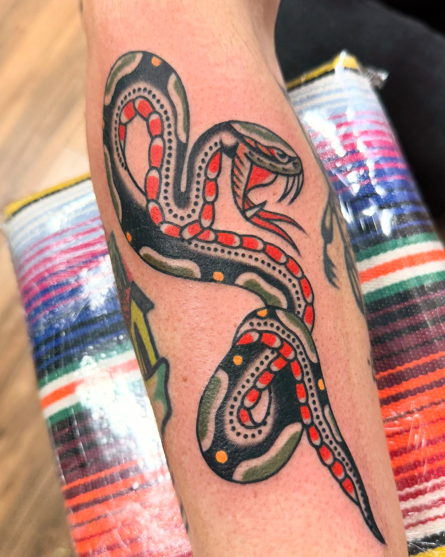 Snake American traditional tattoo on the forearm by Chaz Otto