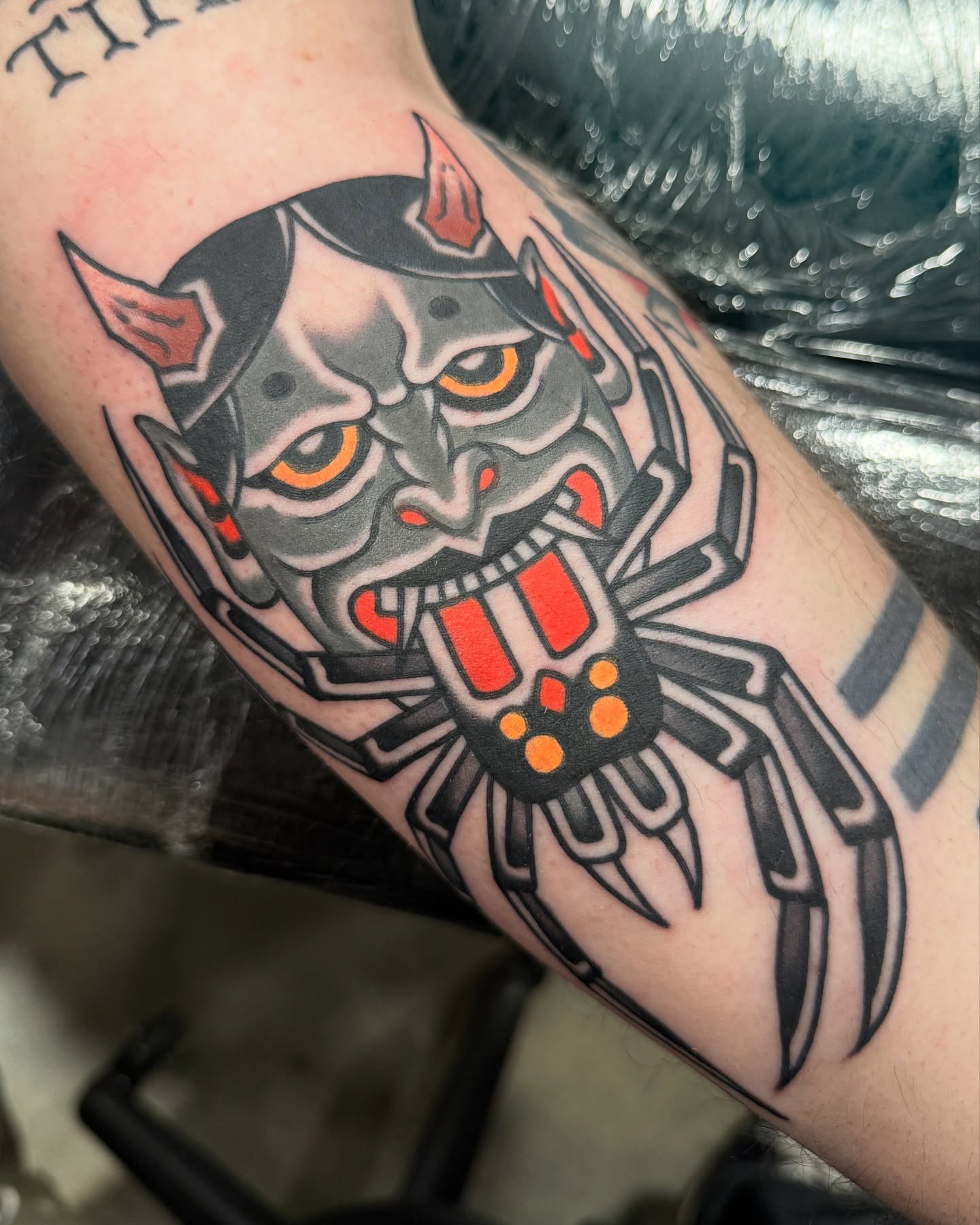 Demon mask American traditional tattoo on the forearm by Chaz Otto