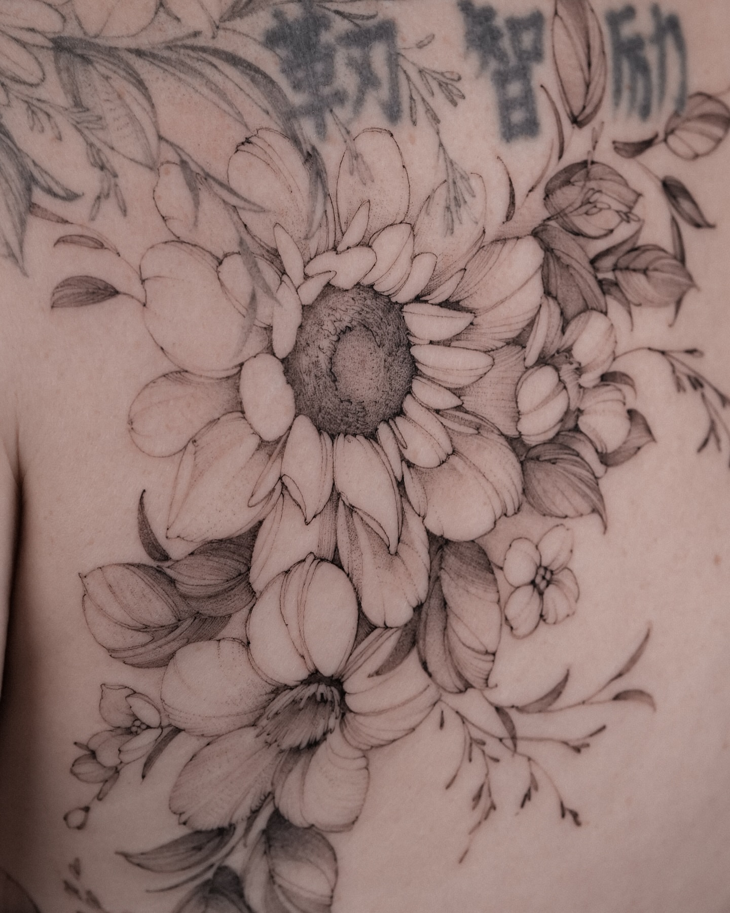 Sunflower bouquet realism tattoo on the chest by Mary Shekh