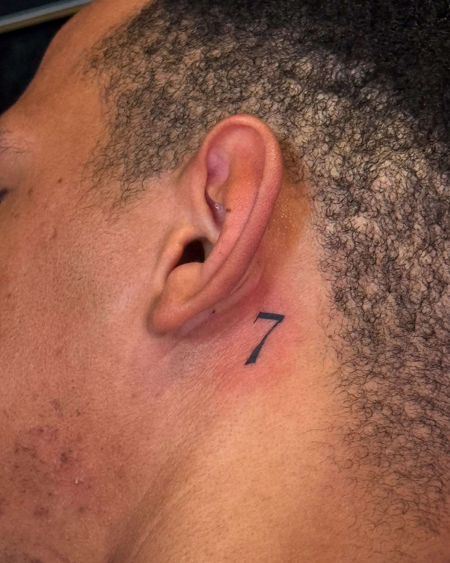 Number 7 lettering script tattoo on the neck by Gabby Finearts
