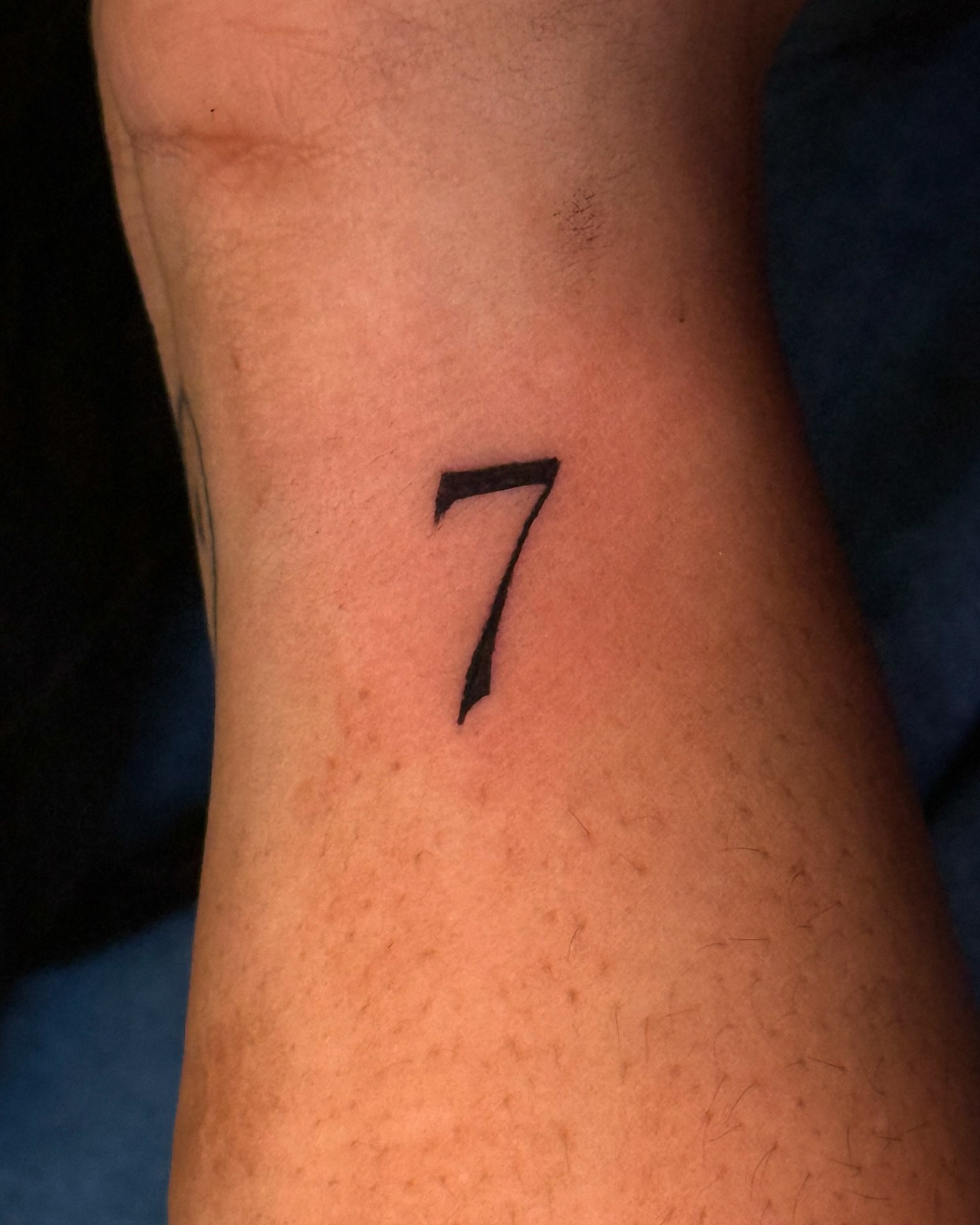 Number 7 lettering script tattoo on the forearm by Gabby Finearts