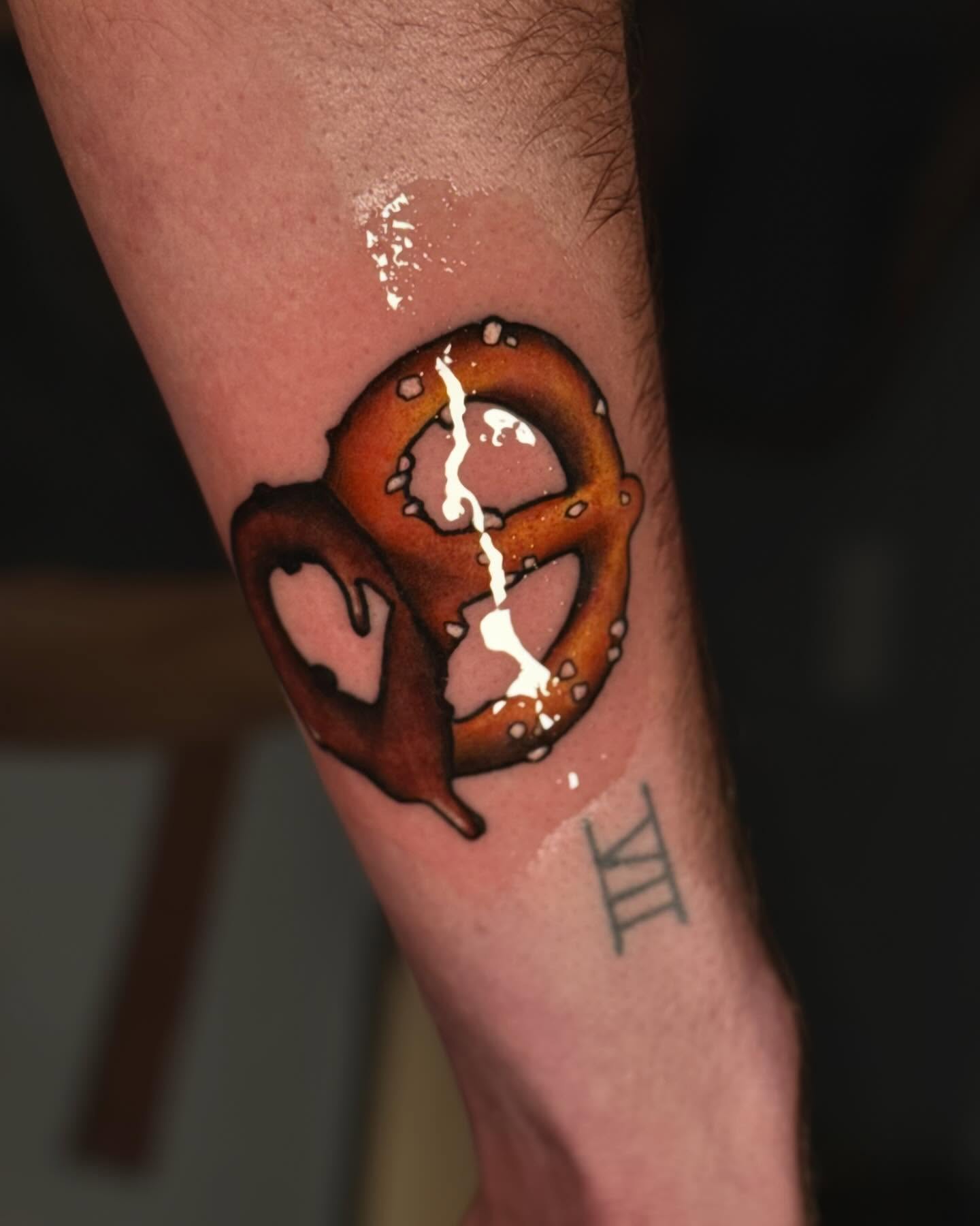 Pretzel realism tattoo on the forearm by laura baldwin