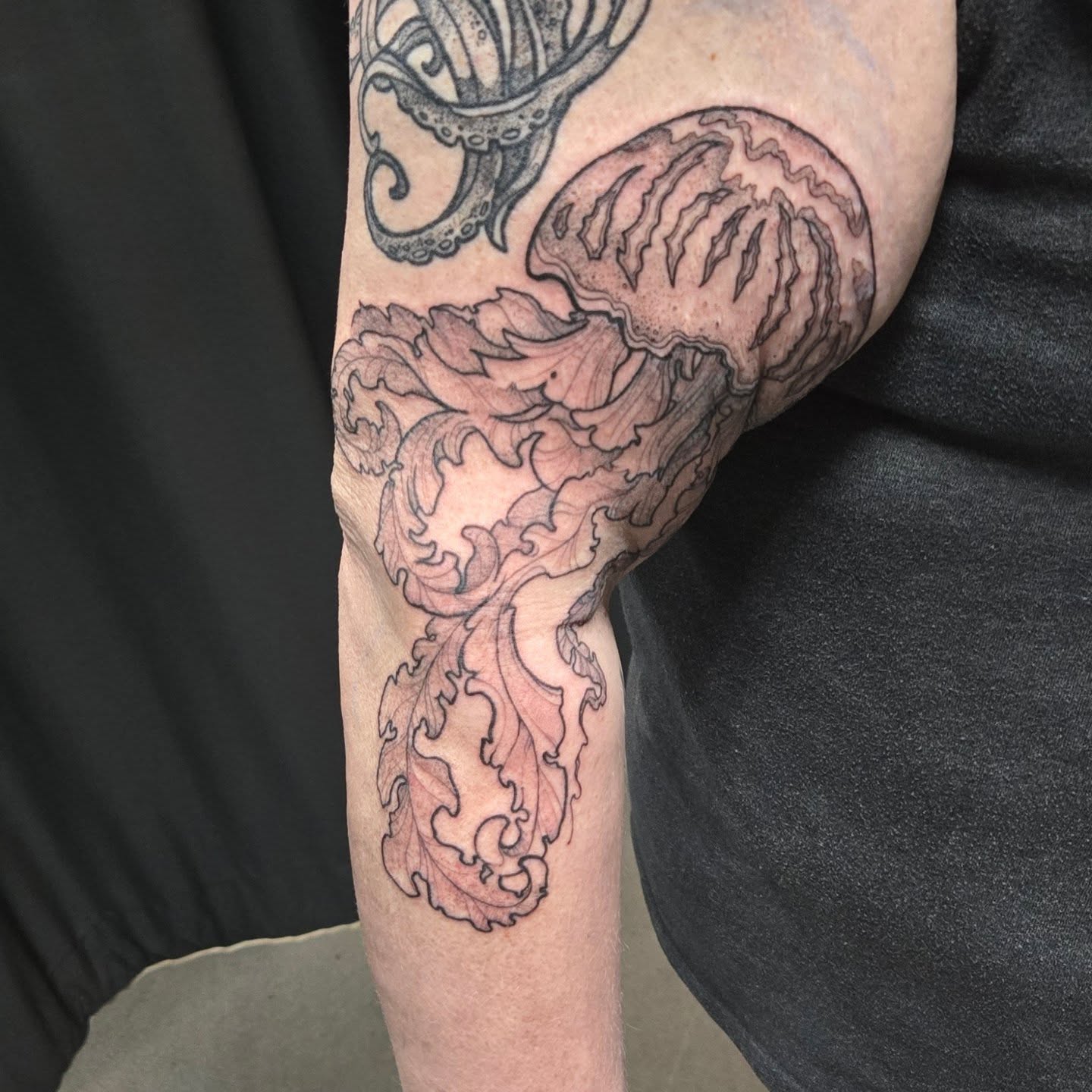 Octopus black and grey tattoo on the forearm by Jamie Clinton