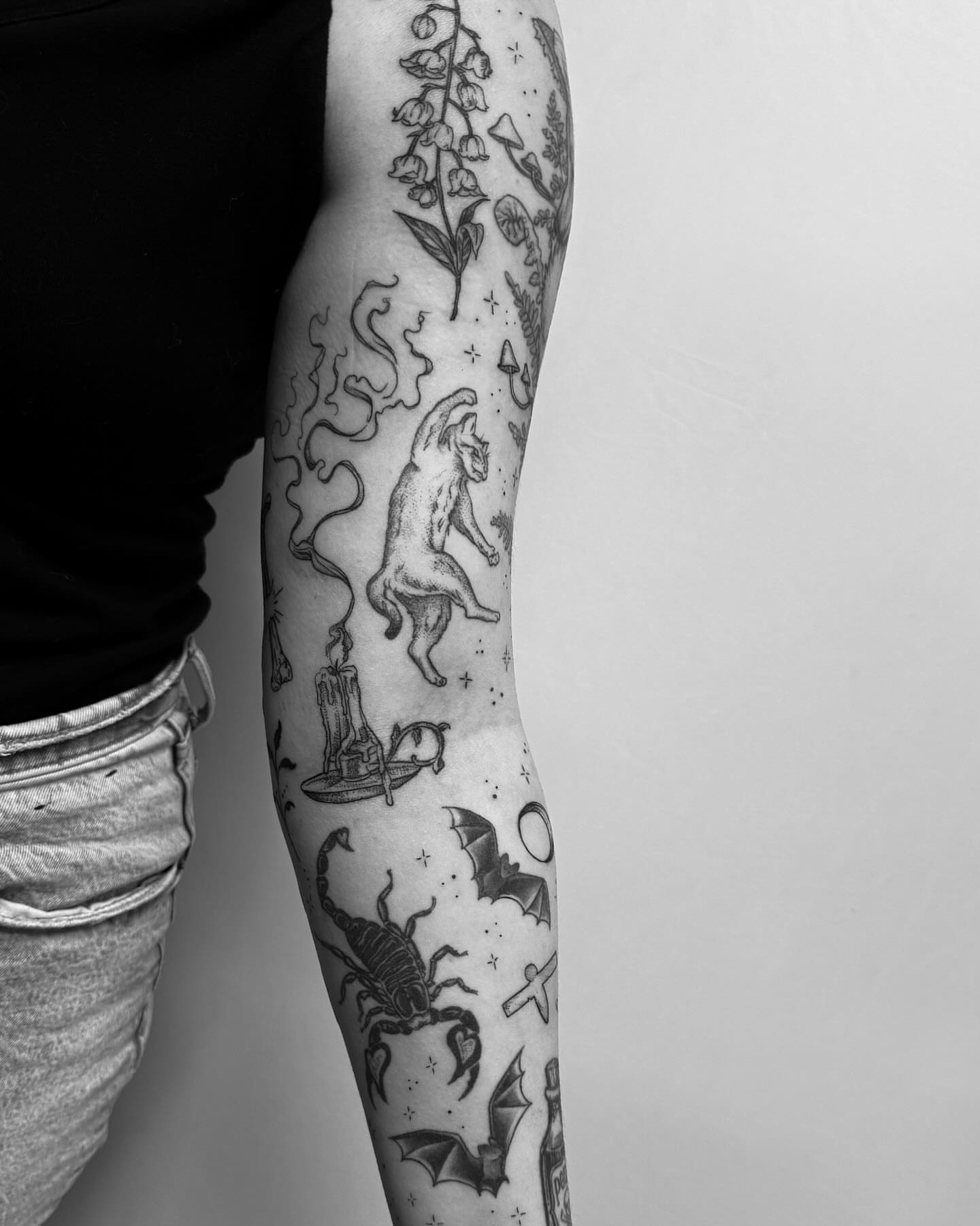 Cat and bat black and grey tattoo on the forearm by Christen Wolfe CA Tattooer
