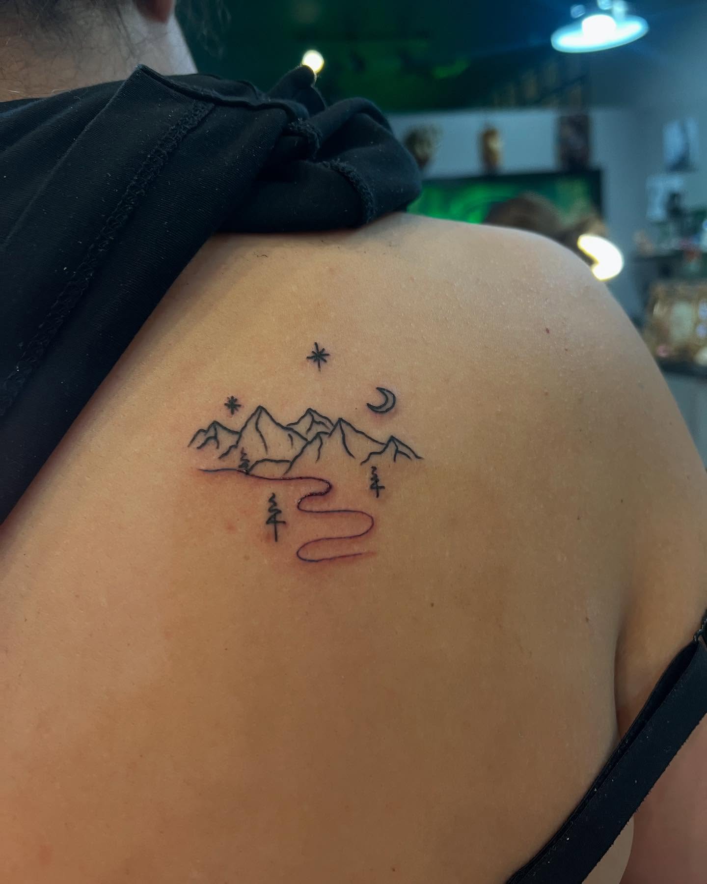 Mountains and river minimalist tattoo on the shoulder by Kai
