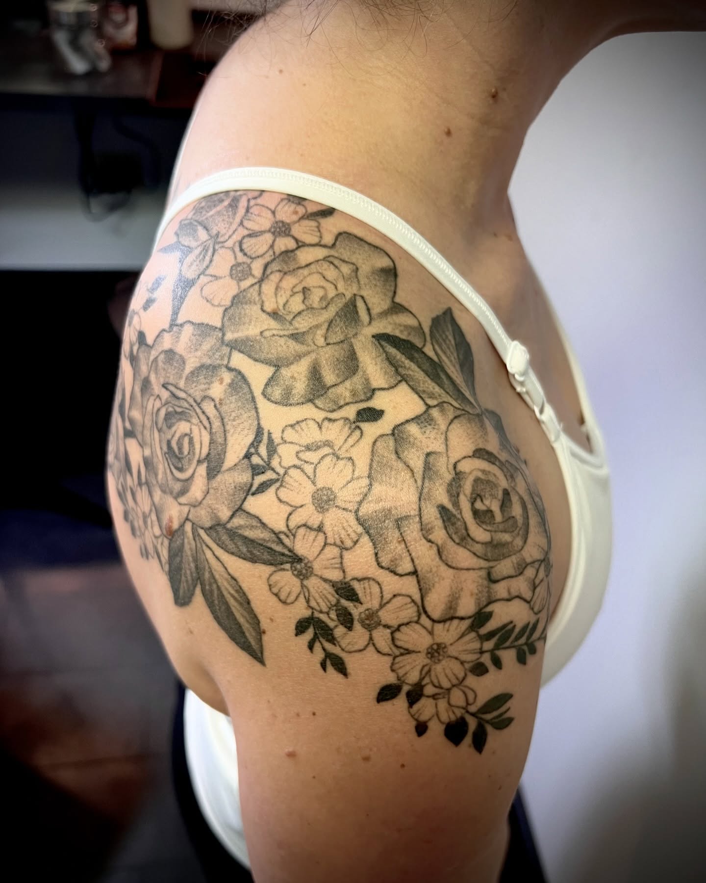 Floral bouquet black and grey tattoo on the shoulder by Tattoos by Katherina, Willoughby, Ohio