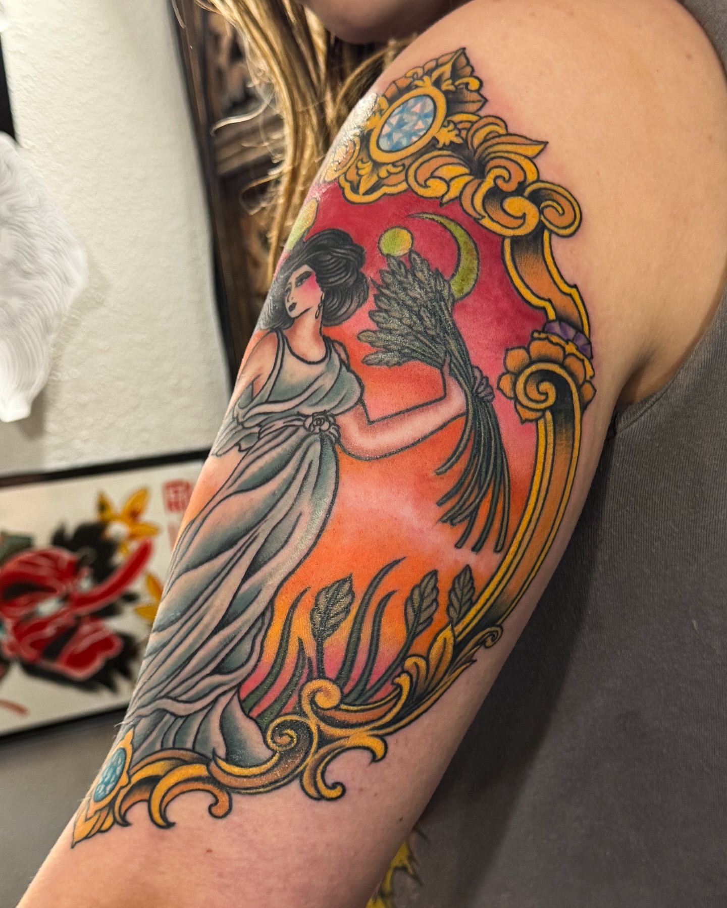 Mythical figure with wheat sheaf American traditional tattoo on the upper arm by Marcos Rivera, Laredo, Texas