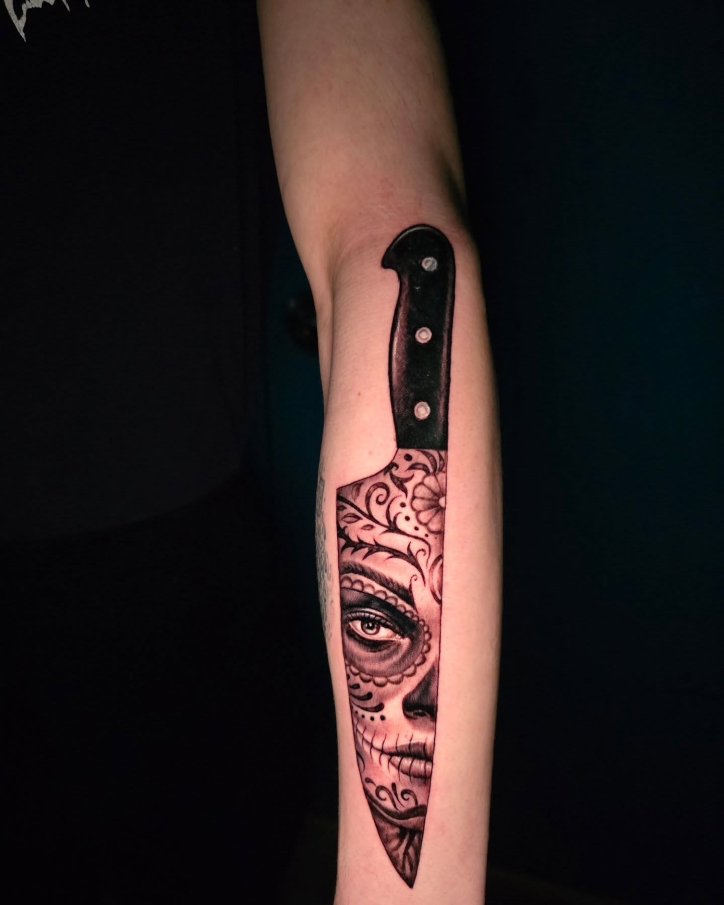 Sugar skull knife realism tattoo on the forearm by Martin Colonna